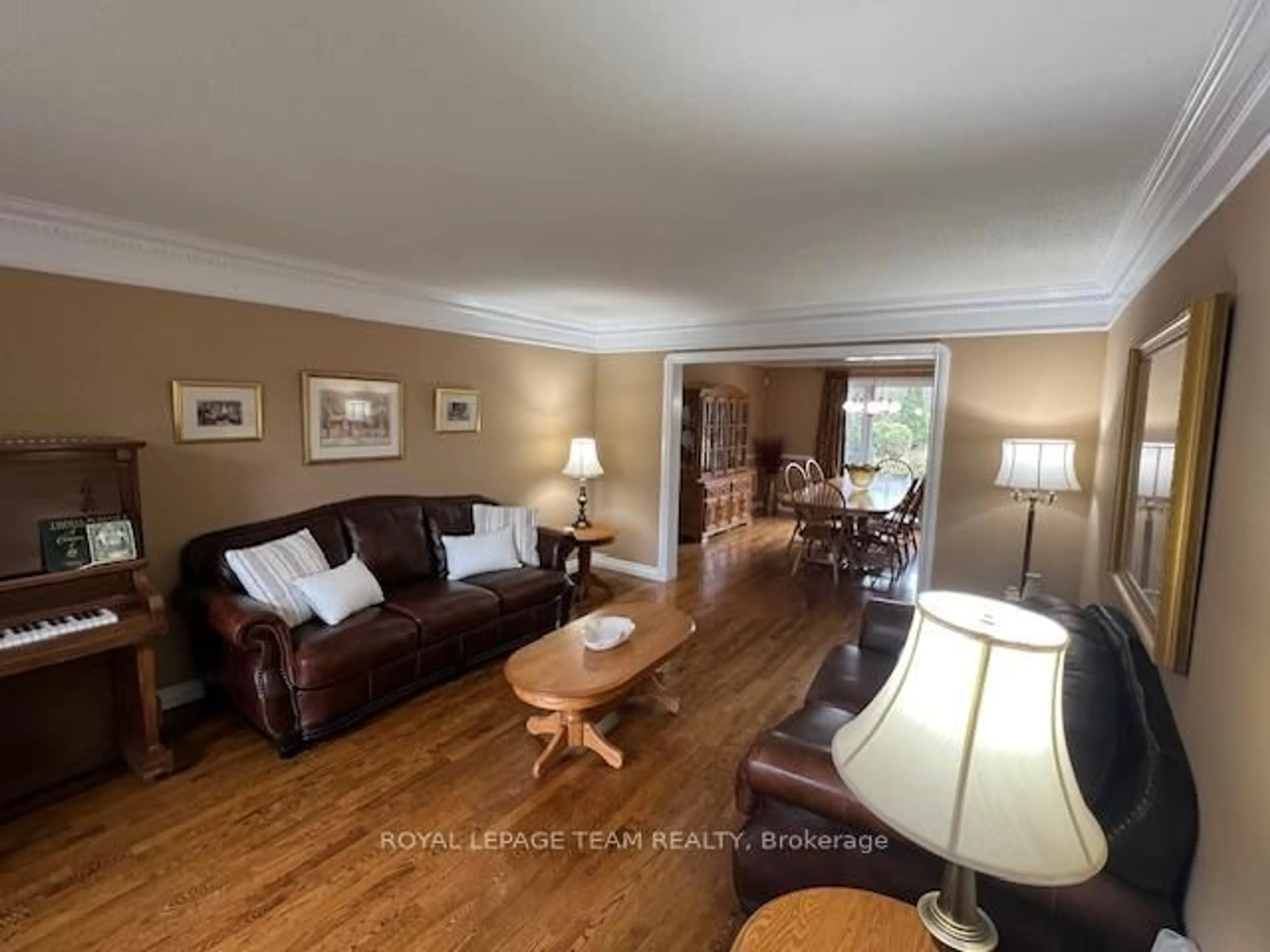 Living room with furniture, wood/laminate floor for 5530 Pettapiece Cres, Ottawa Ontario K4M 1C5