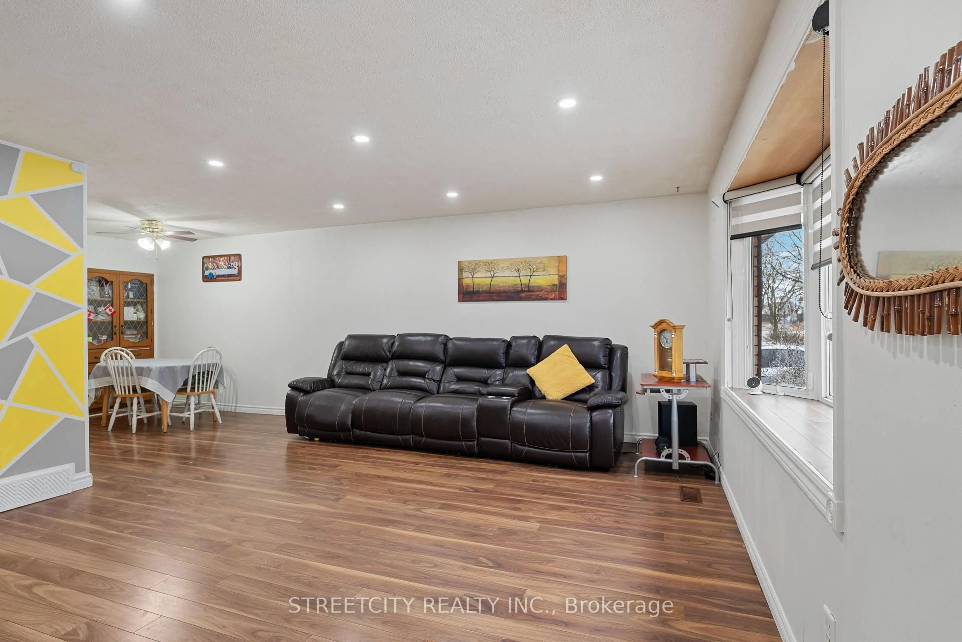 Living room with furniture, wood/laminate floor for 54 Brennan Dr, Strathroy-Caradoc Ontario N7G 3S3