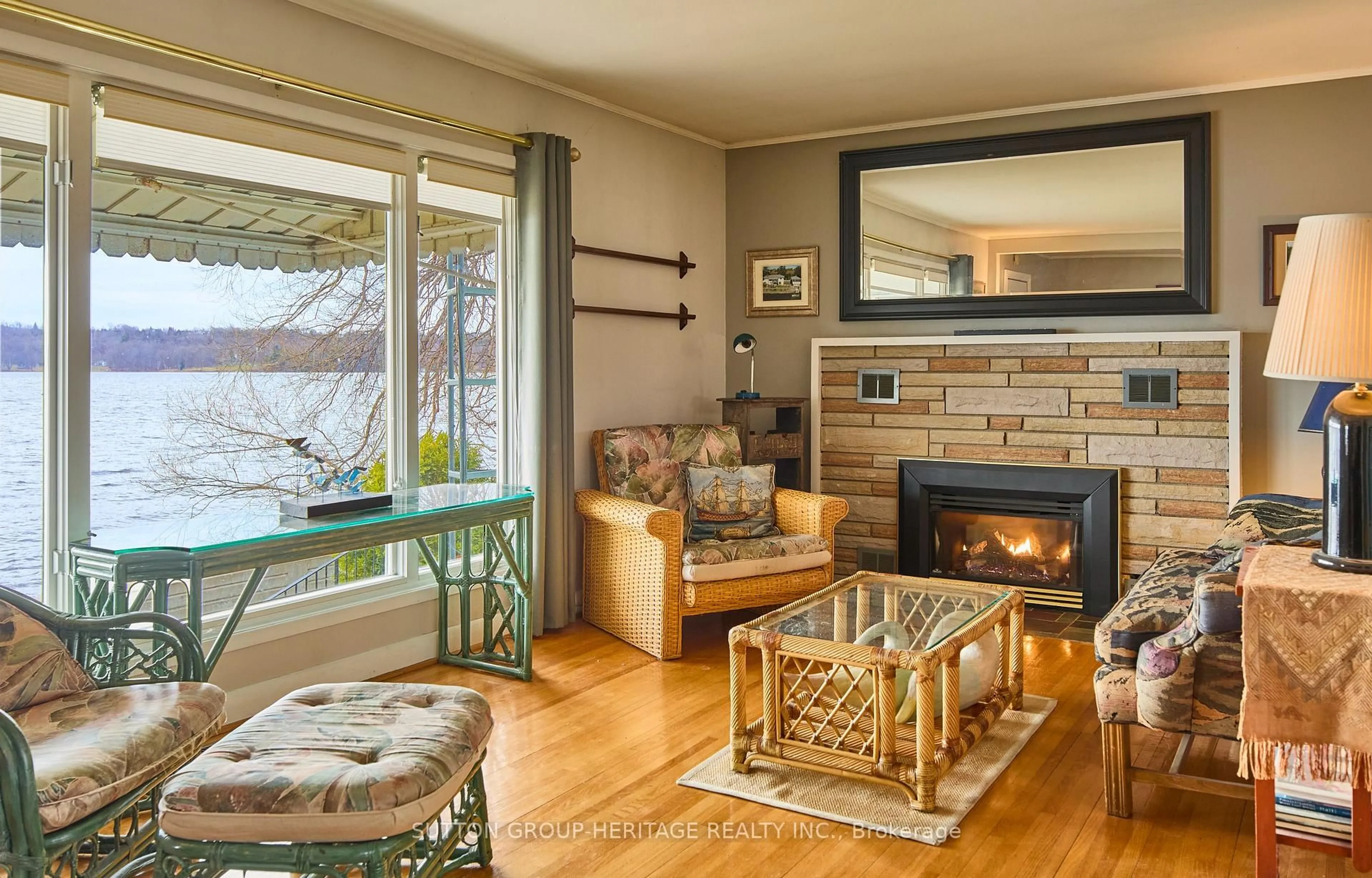 Living room with furniture, wood/laminate floor for 11056 Loyalist Pkwy, Bath Ontario K0H 1G0