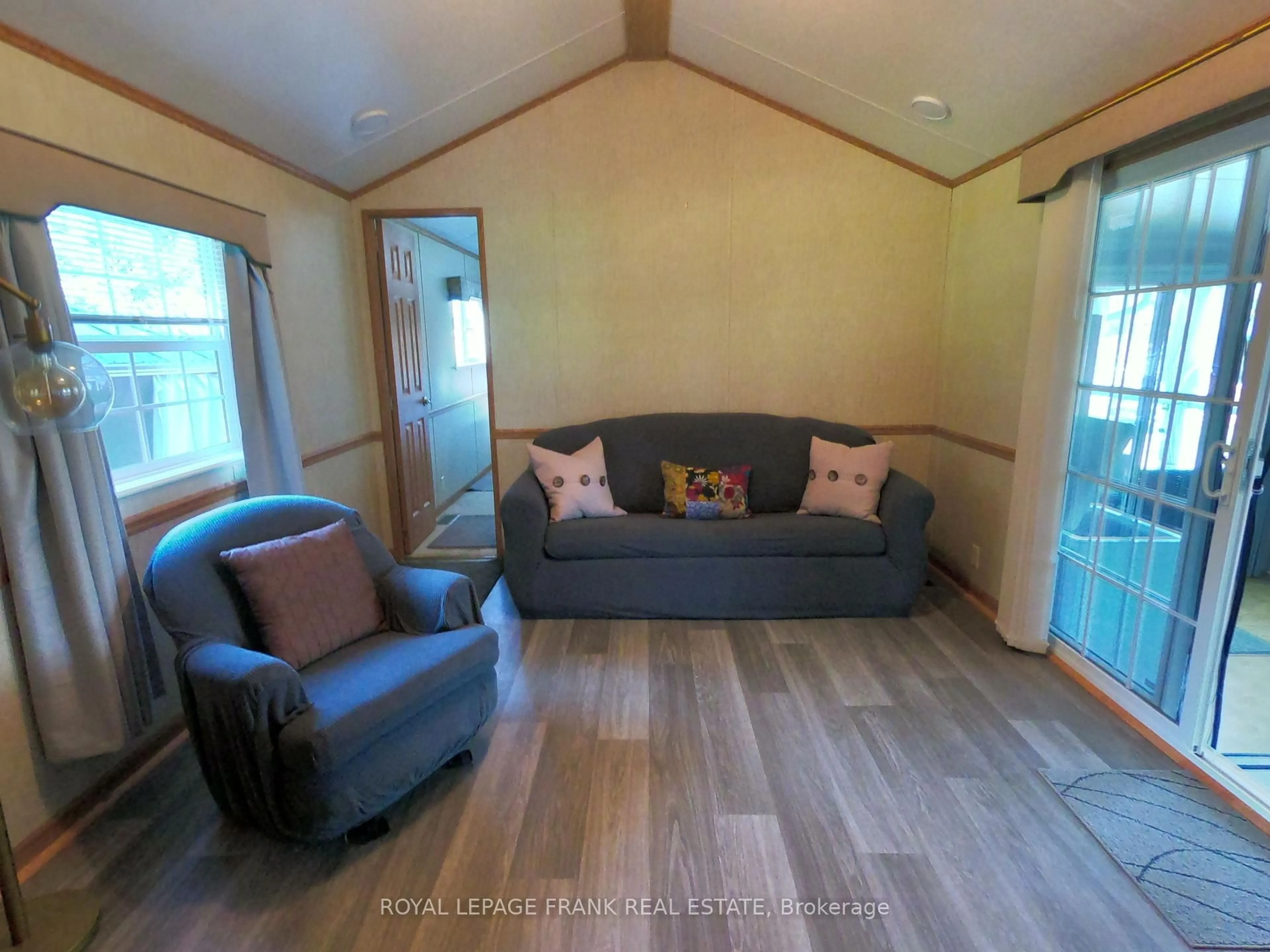 Living room with furniture, wood/laminate floor for 14 Pioneer Dr, Otonabee-South Monaghan Ontario K0L 2G0
