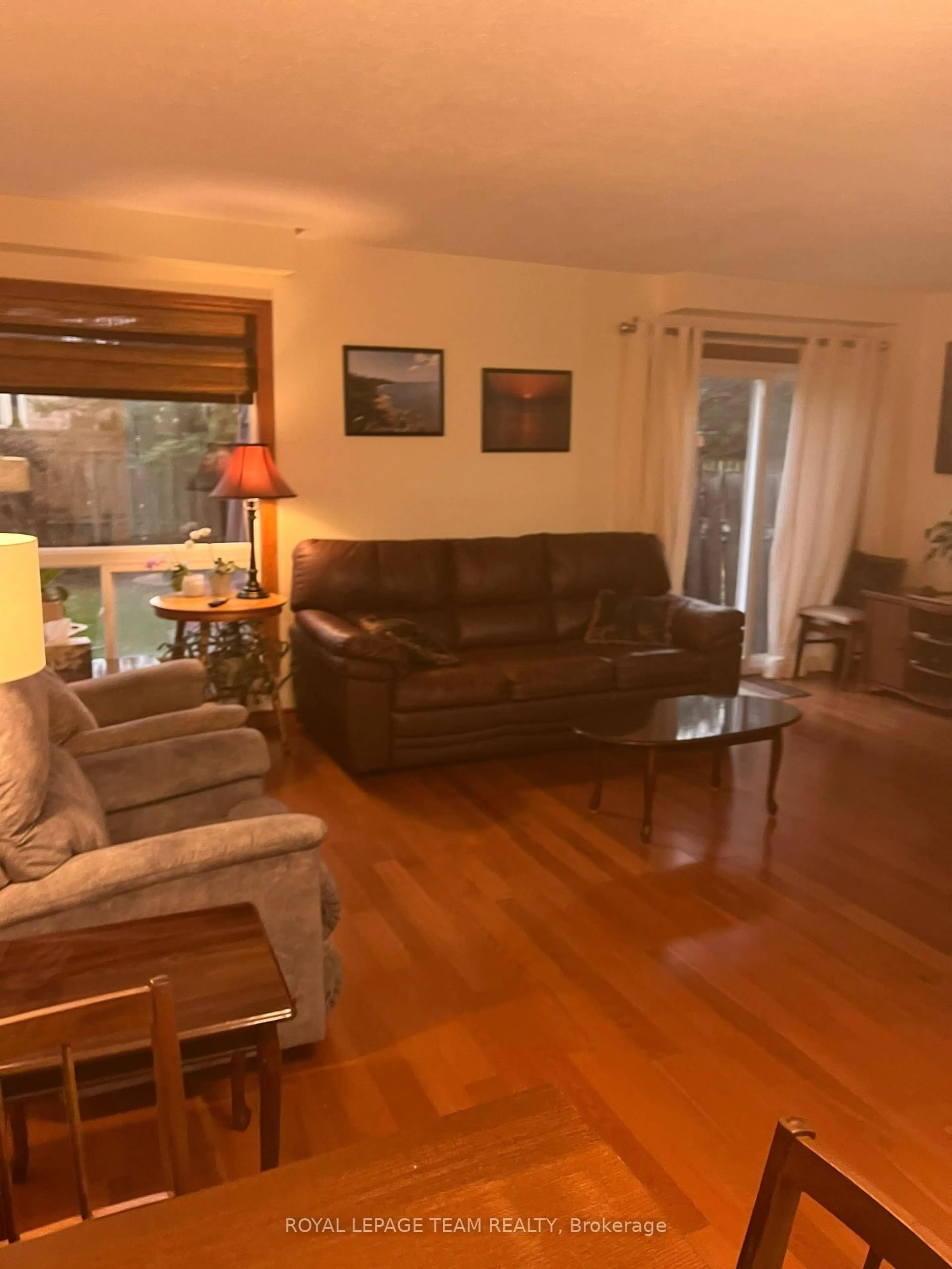 Living room with furniture, wood/laminate floor for 61 McGibbon Dr, Kanata Ontario K2L 4A6