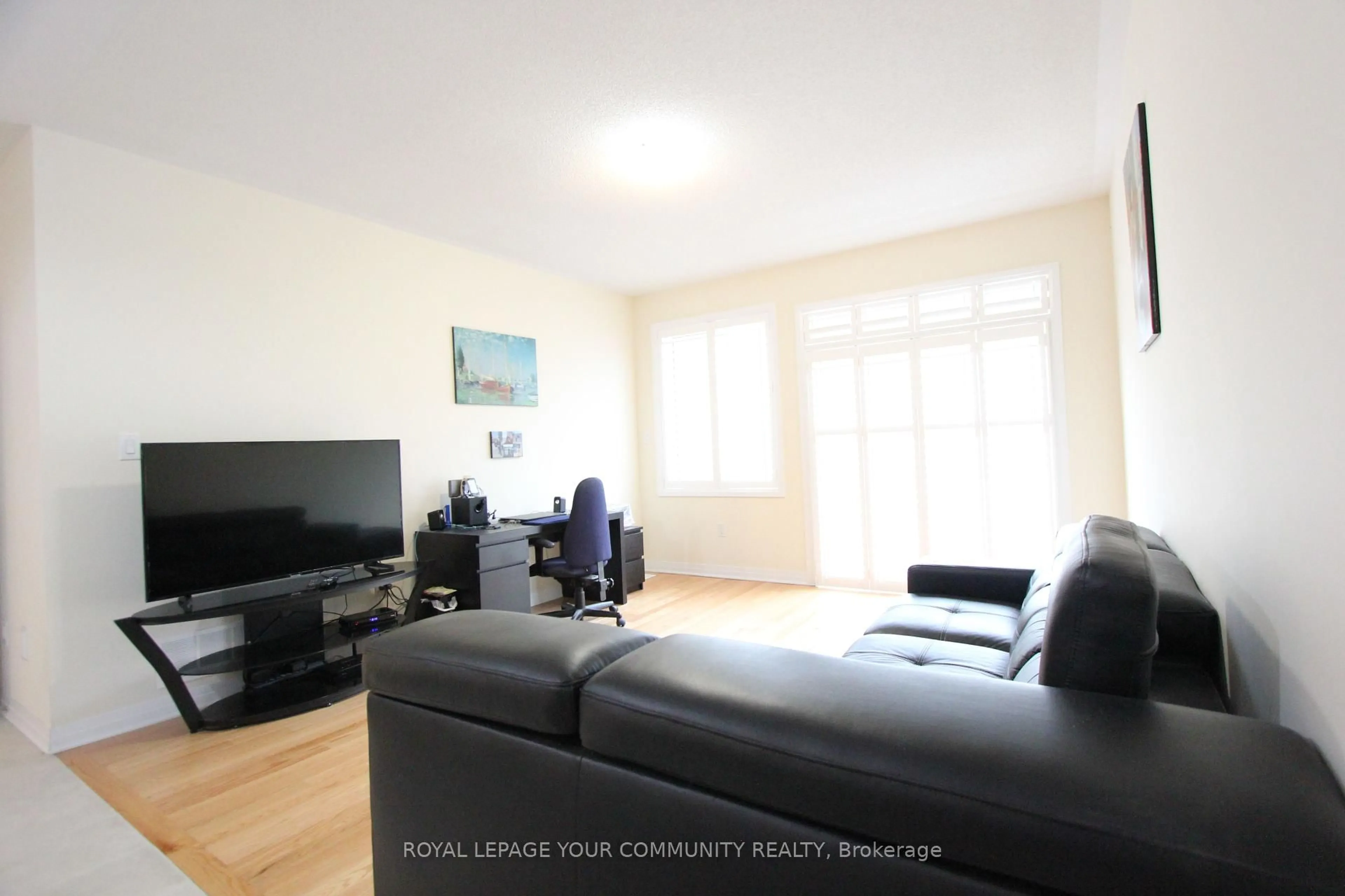 Living room with furniture, wood/laminate floor for 42 Northhill Ave, Cavan Monaghan Ontario L4A 1G0