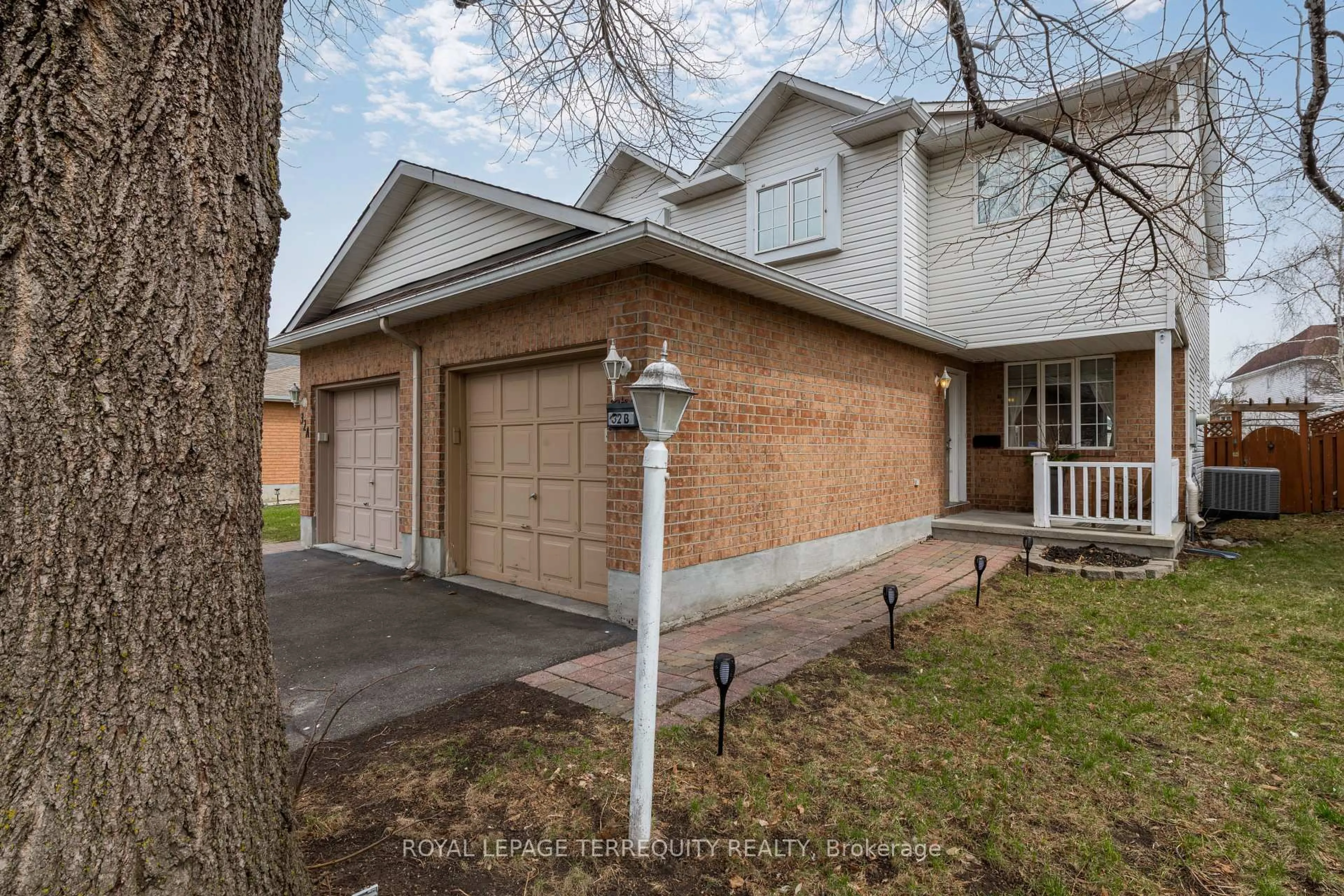 Home with brick exterior material, street for 32B Woodford Way, Ottawa Ontario K2J 4B9