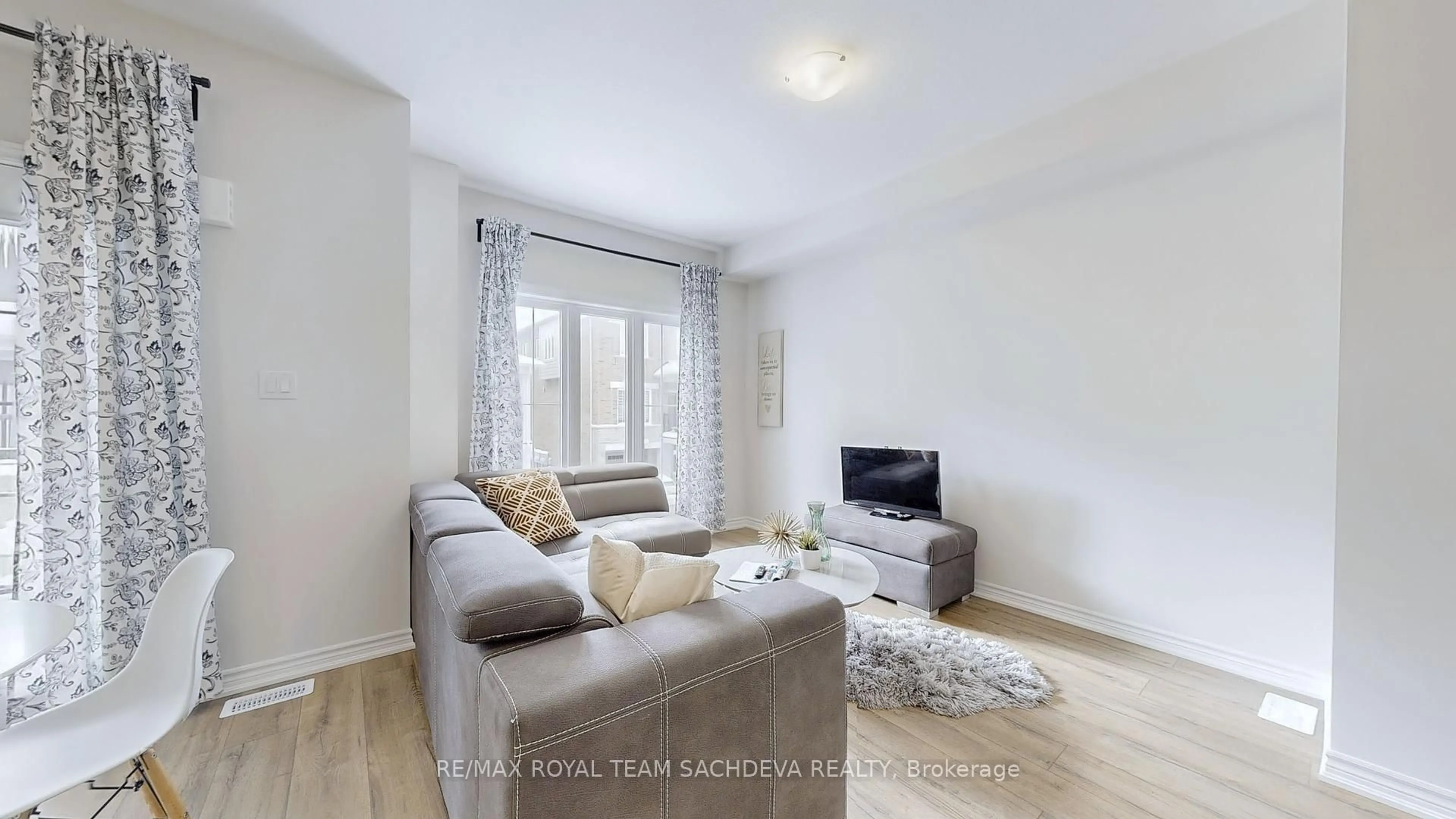 Living room with furniture, wood/laminate floor for 677 Park Rd #140, Brantford Ontario N3R 0C2