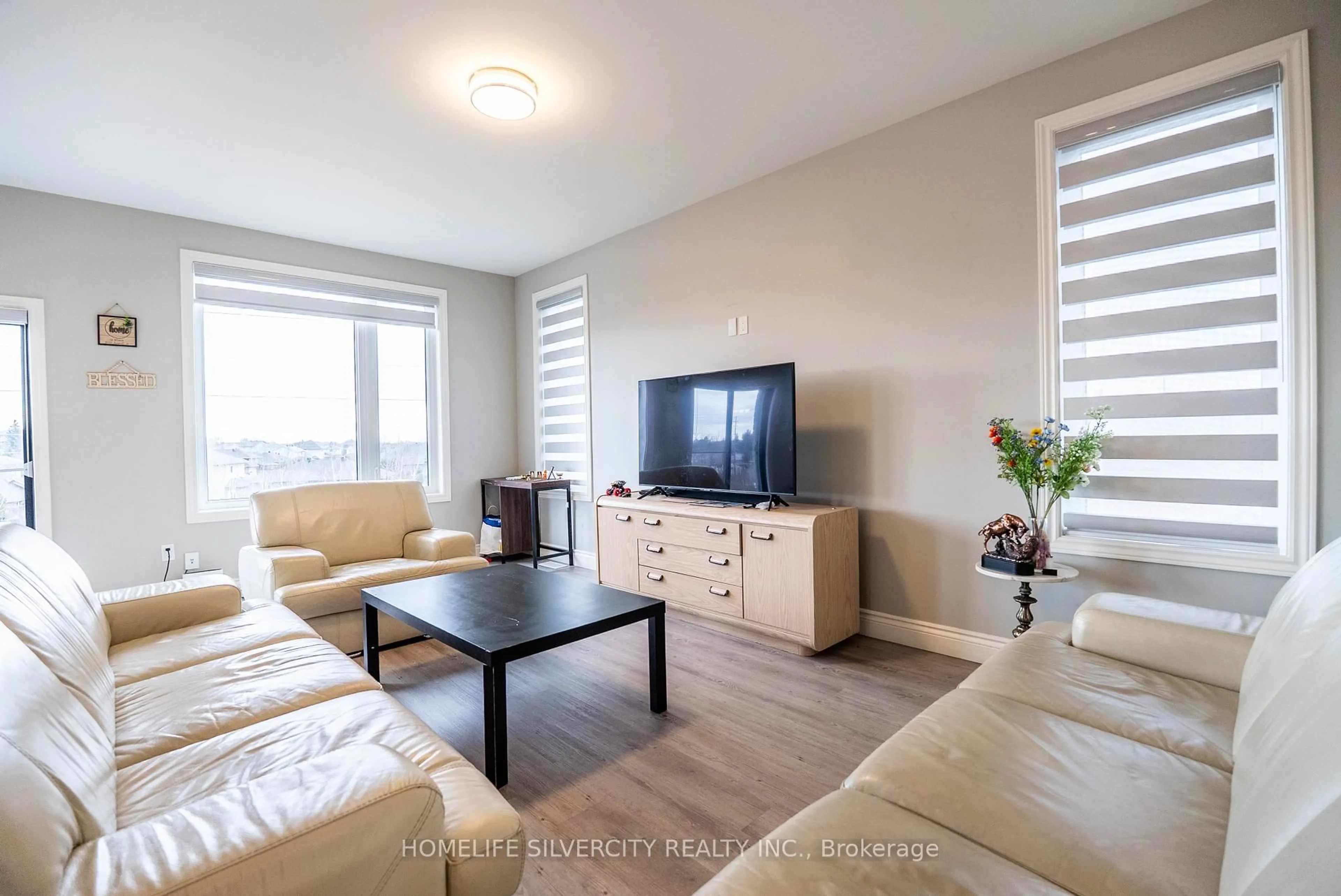 Living room with furniture, wood/laminate floor for 503 Bonaventure Crt, Greater Sudbury Ontario P3A 0B4