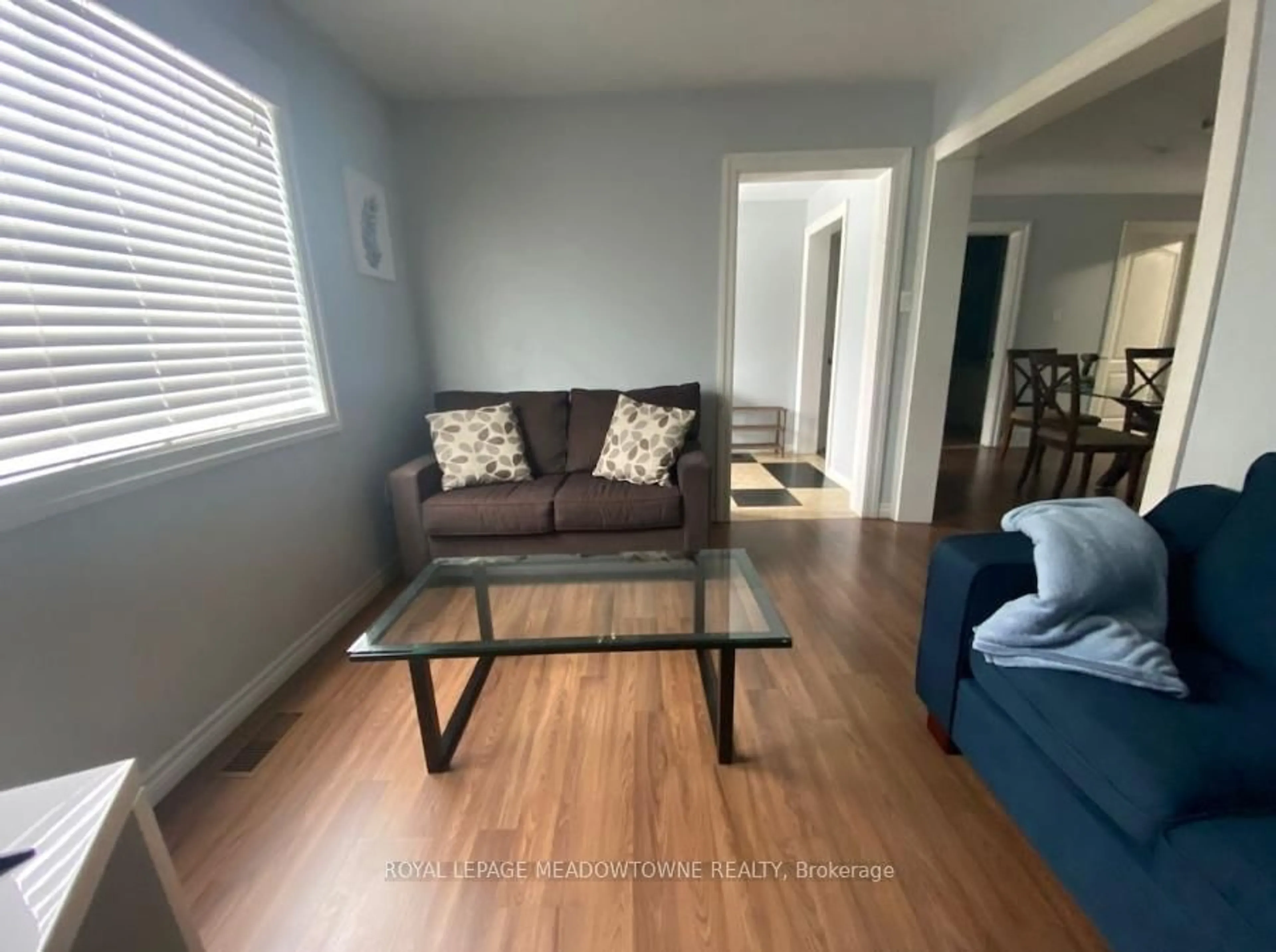 Living room with furniture, wood/laminate floor for 557 Geneva St, St. Catharines Ontario L2N 2J1