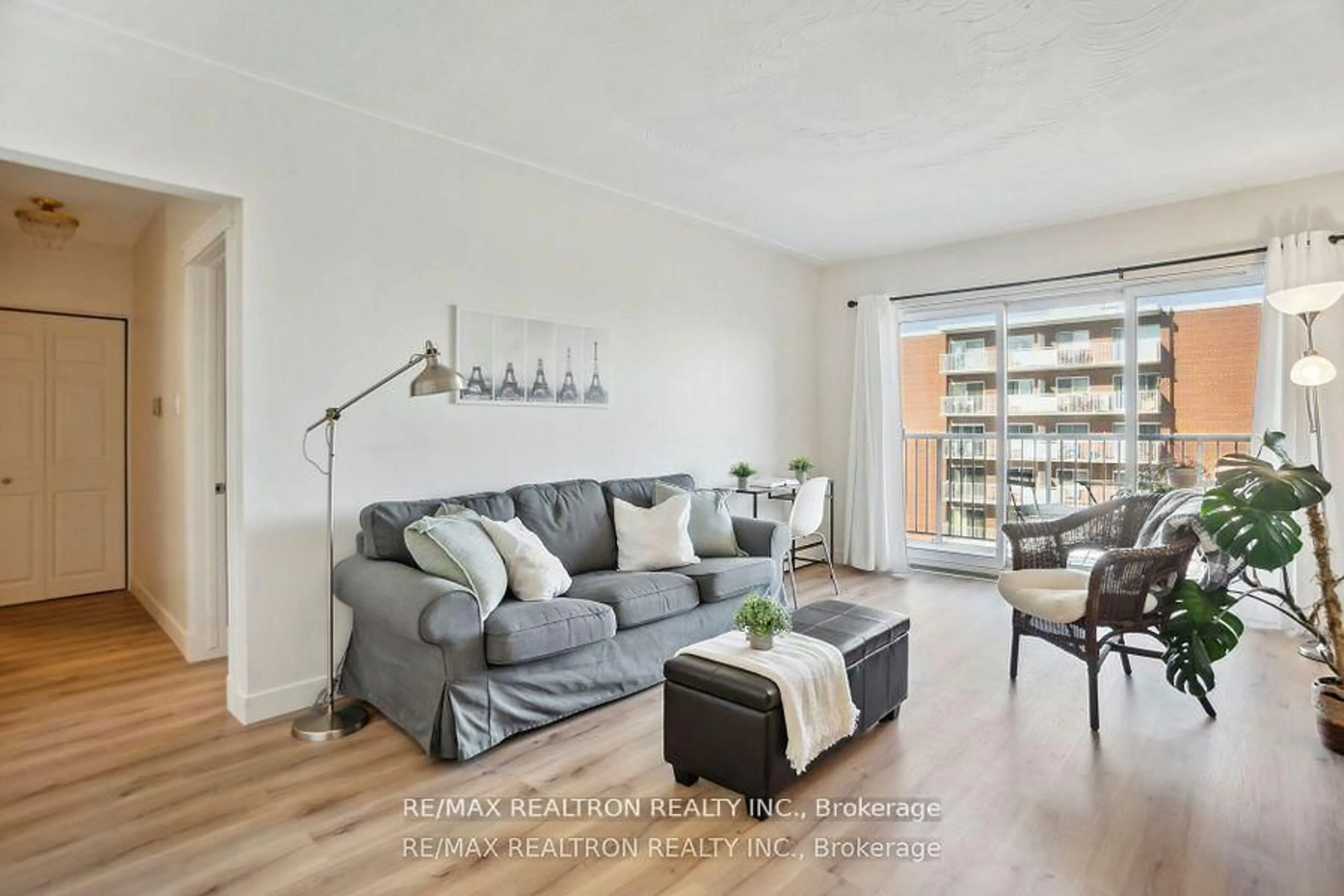 Living room with furniture, wood/laminate floor for 10 Woodman Dr #605, Hamilton Ontario L8K 4E1