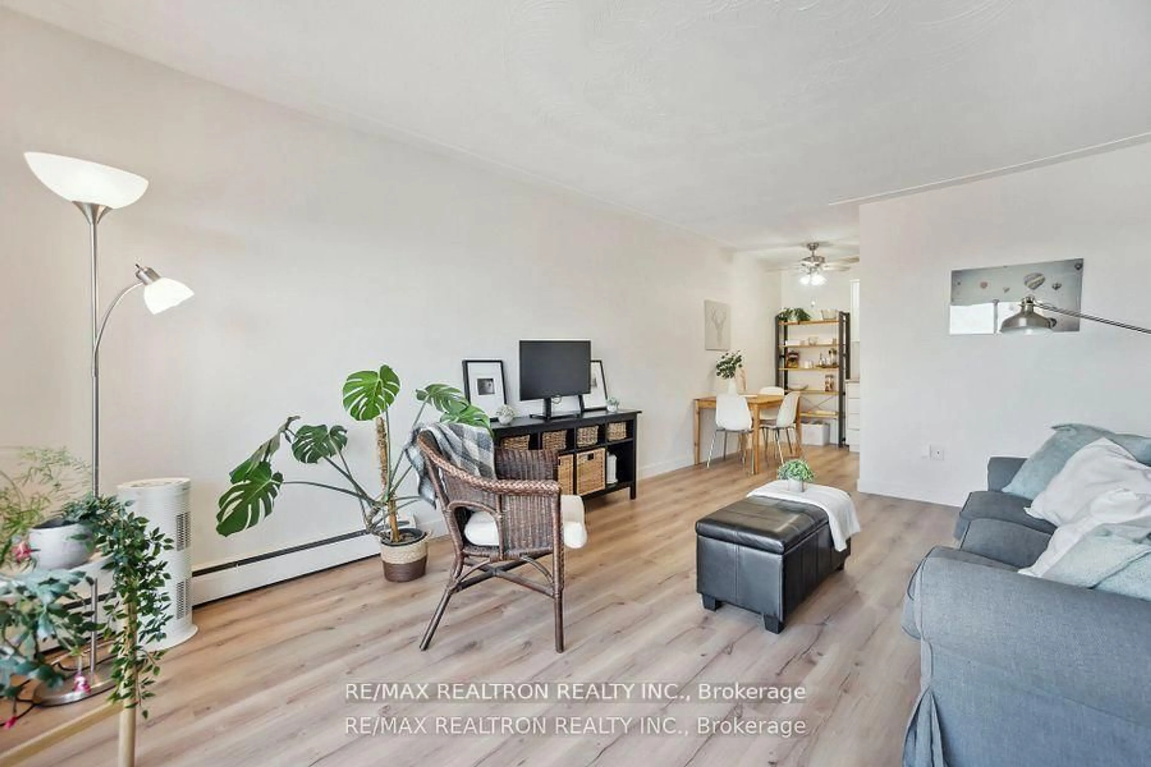 Living room with furniture, wood/laminate floor for 10 Woodman Dr #605, Hamilton Ontario L8K 4E1