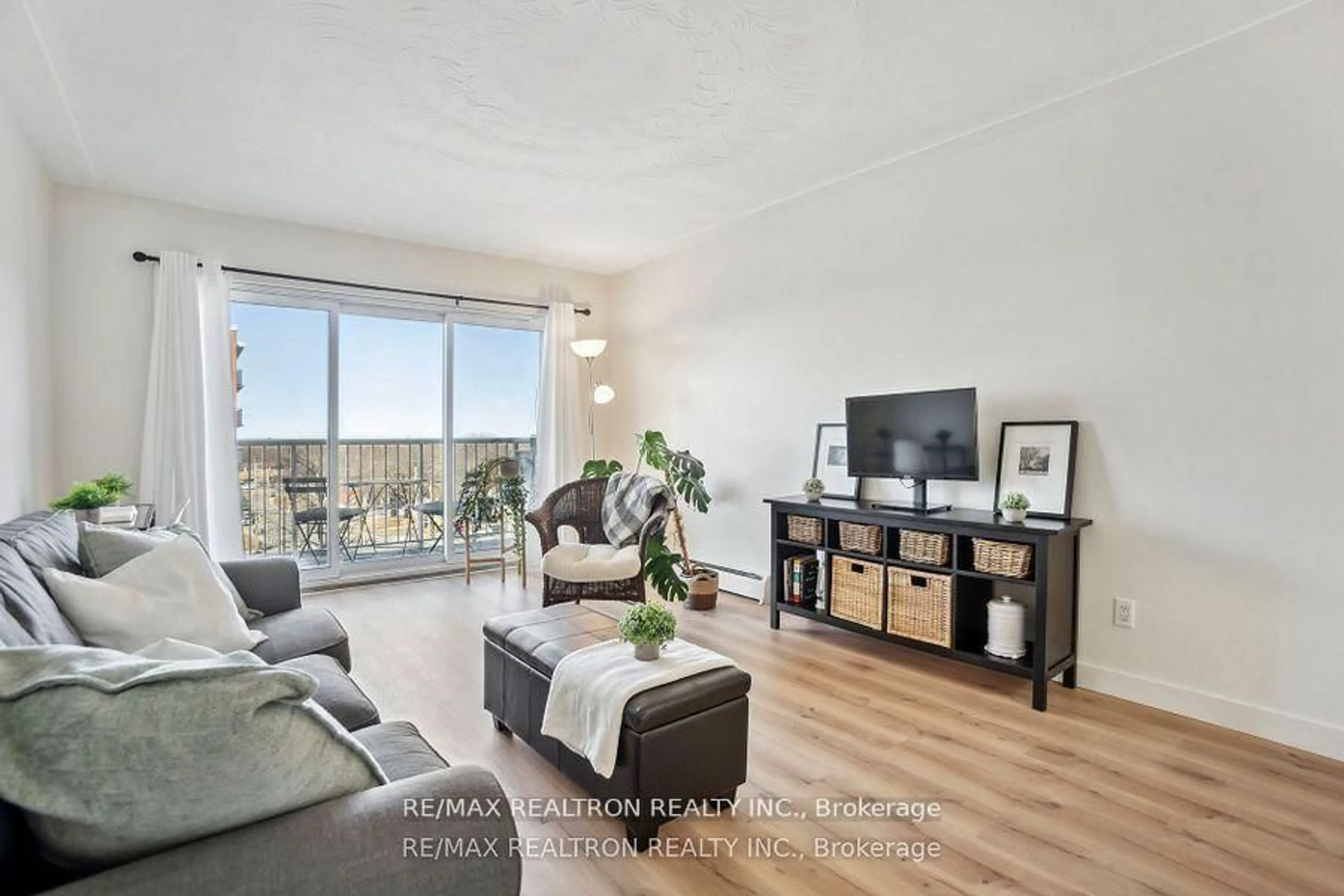 Living room with furniture, wood/laminate floor for 10 Woodman Dr #605, Hamilton Ontario L8K 4E1