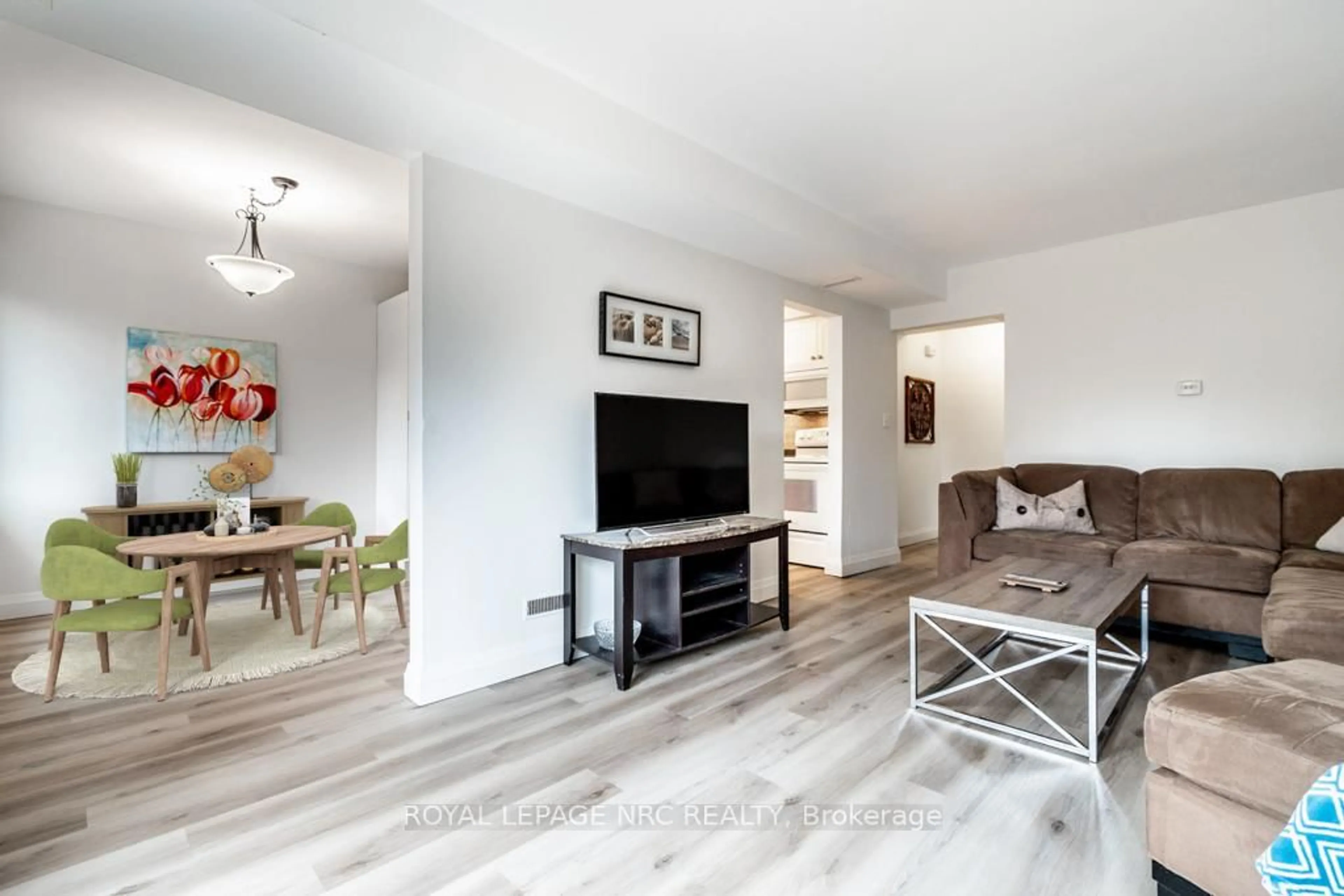 Living room with furniture, wood/laminate floor for 151 Parnell Rd #57, St. Catharines Ontario L2M 3S4