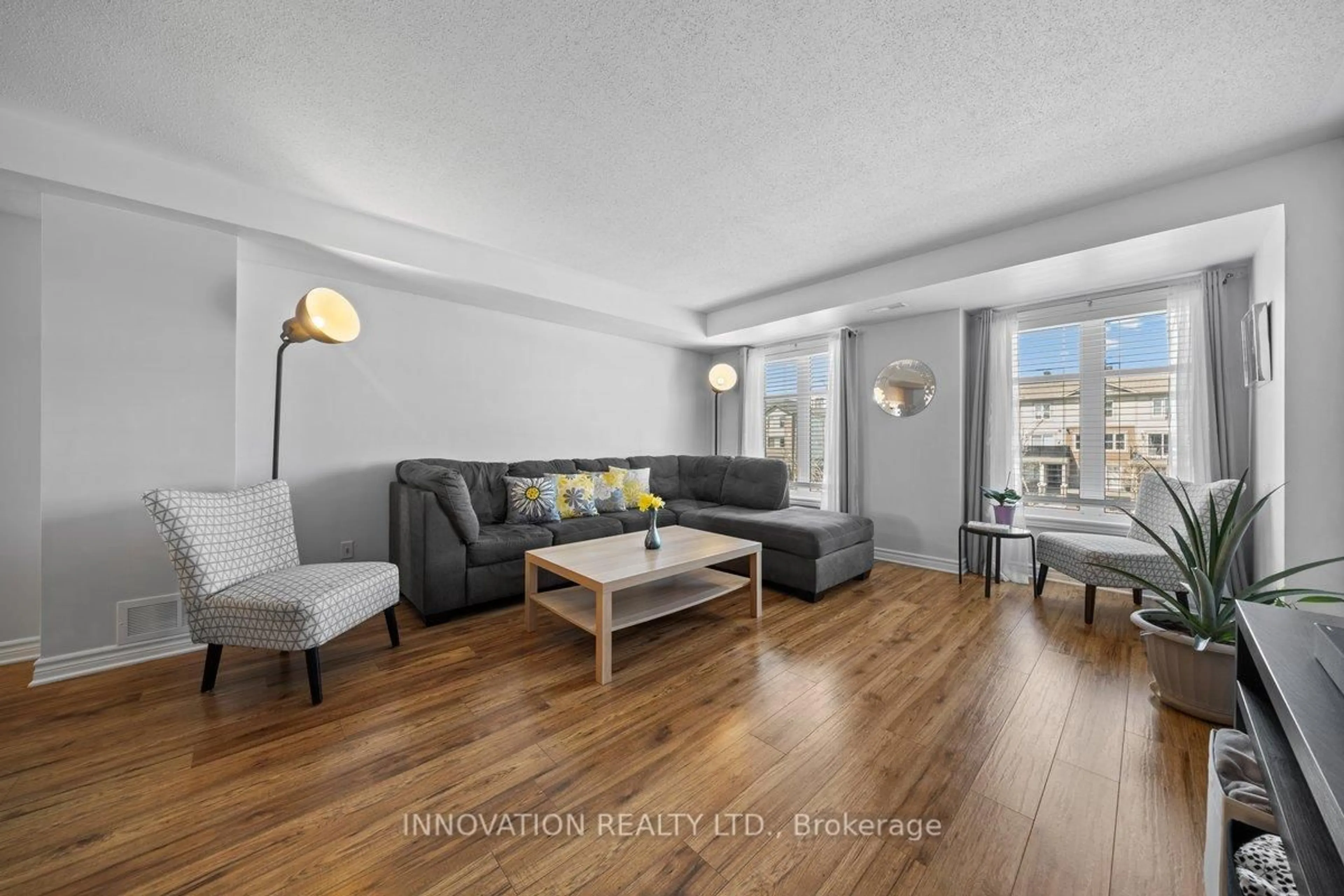Living room with furniture, wood/laminate floor for 742b Chapman Mills Dr, Ottawa Ontario K2J 3V2