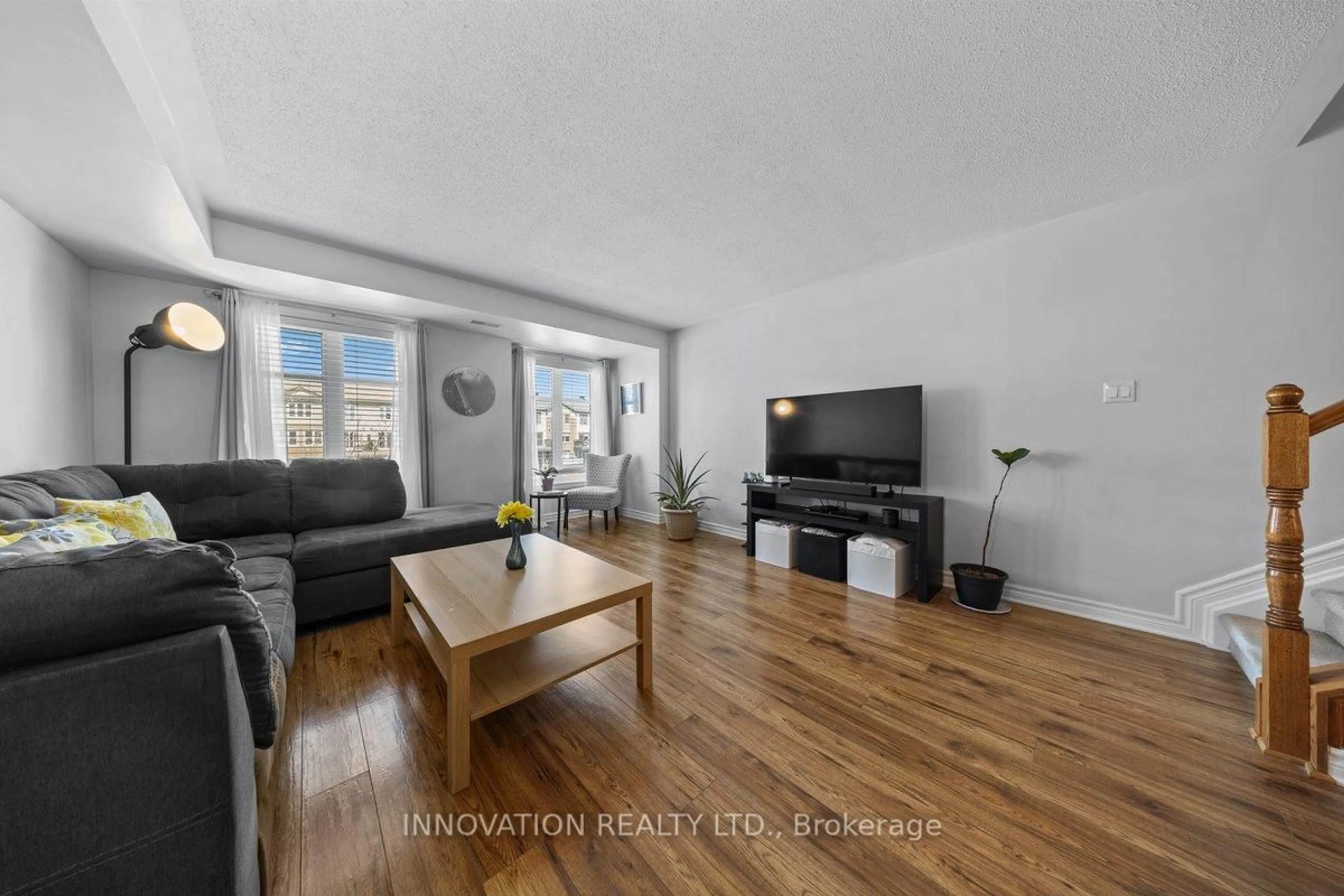 Living room with furniture, wood/laminate floor for 742b Chapman Mills Dr, Ottawa Ontario K2J 3V2