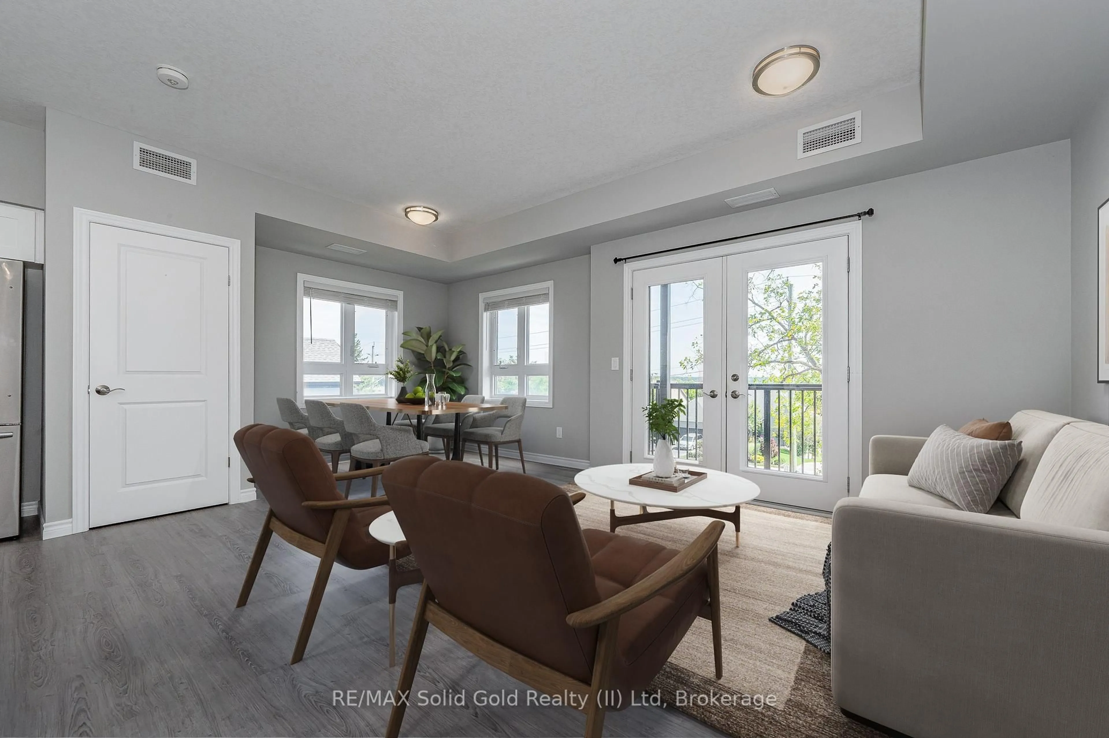 Living room with furniture, wood/laminate floor for 408 GUELPH Ave #210, Cambridge Ontario N3C 0H3