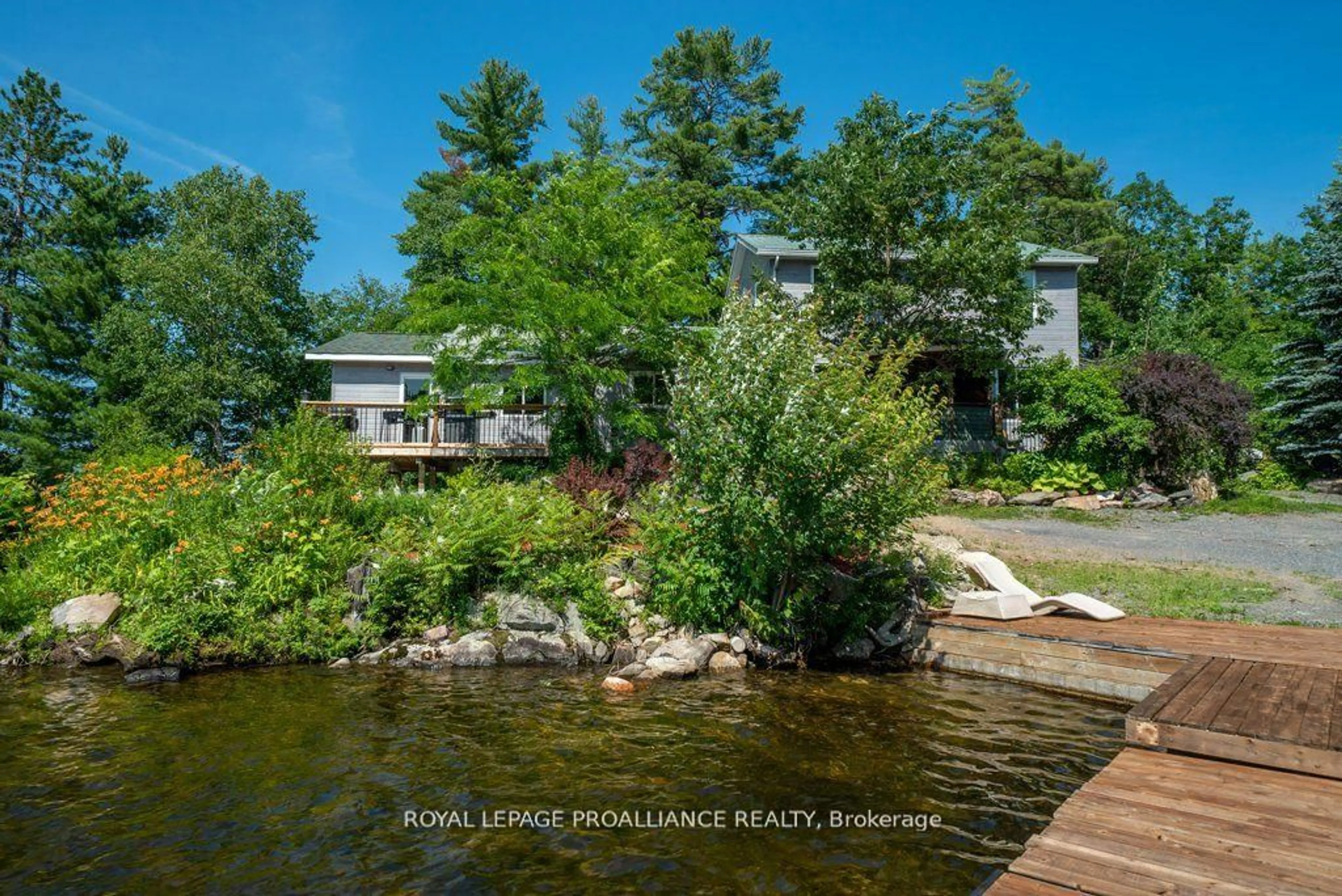 A pic from outside/outdoor area/front of a property/back of a property/a pic from drone, water/lake/river/ocean view for 2475 Alf's Bay Lane, Arden Ontario K0H 1B0