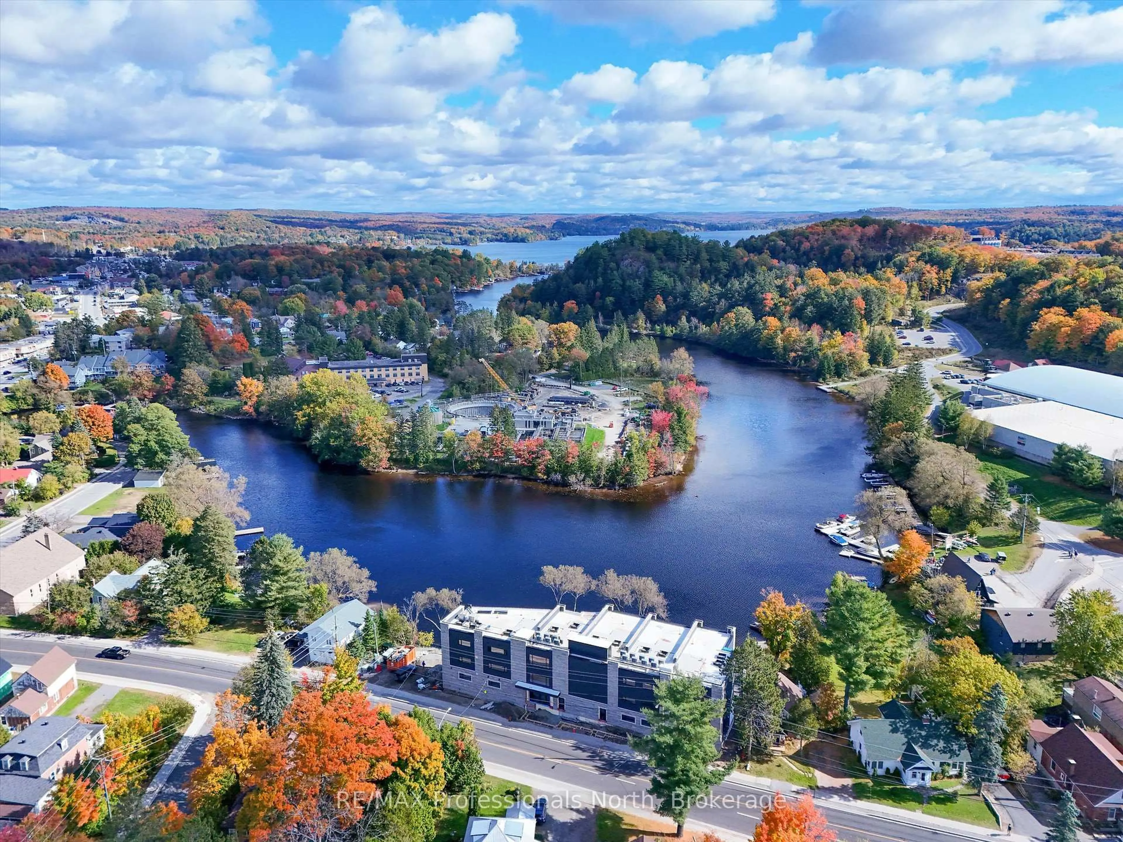 A pic from outside/outdoor area/front of a property/back of a property/a pic from drone, water/lake/river/ocean view for 32 BRUNEL Rd #203, Huntsville Ontario P1H 1P5