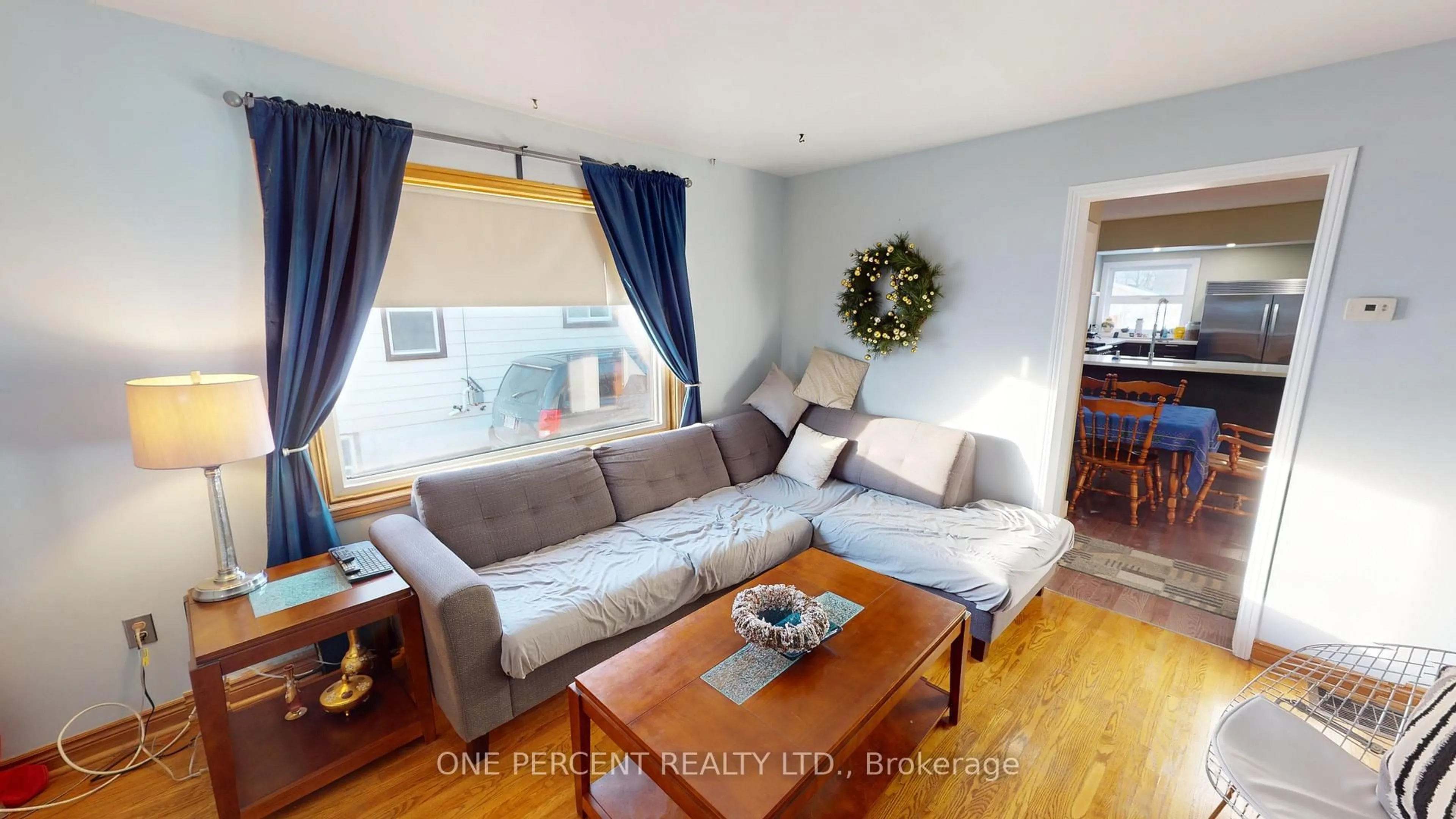 Living room with furniture, wood/laminate floor for 61 Hamilton St, St. Catharines Ontario L2S 1K8