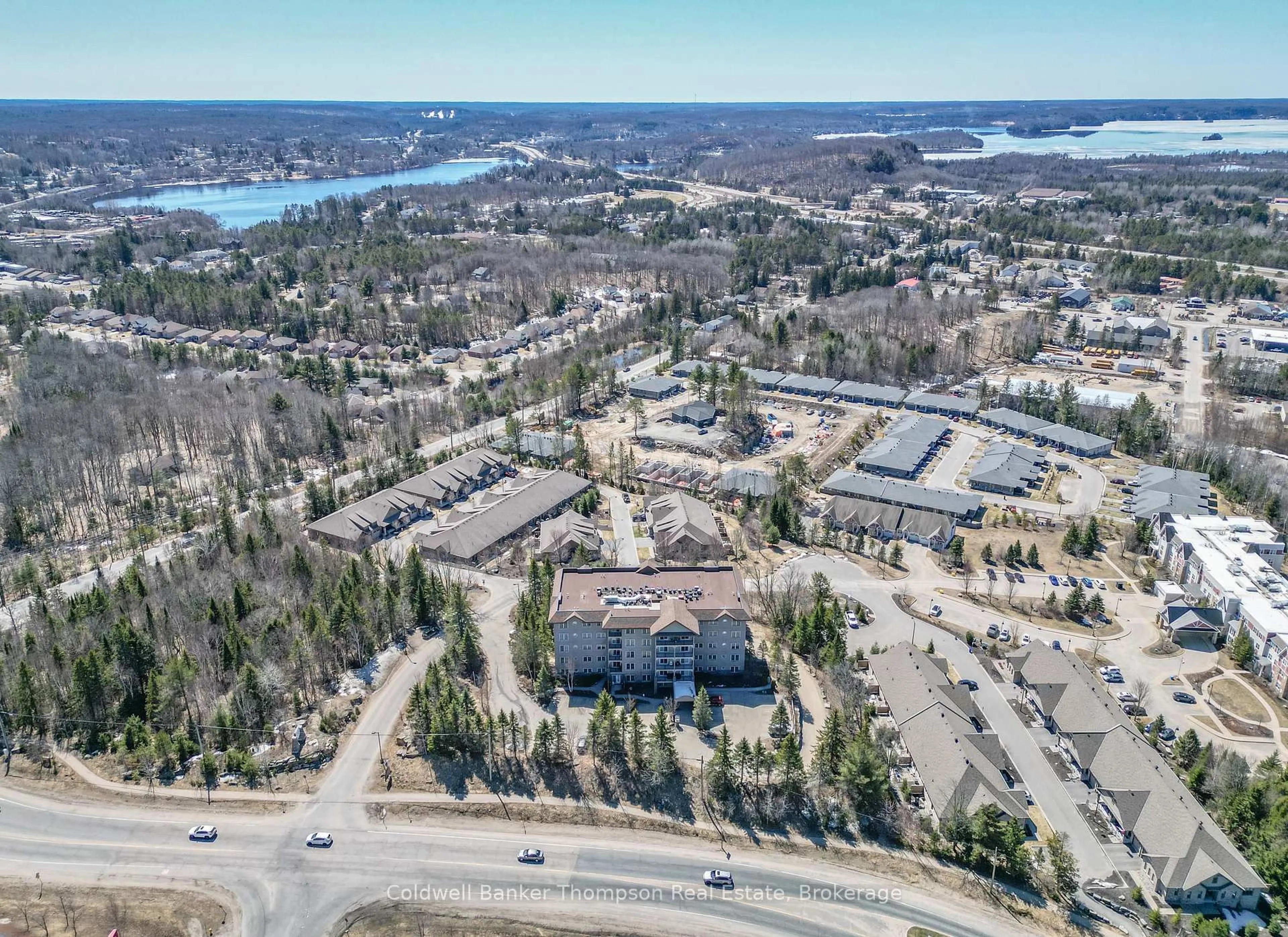 A pic from outside/outdoor area/front of a property/back of a property/a pic from drone, water/lake/river/ocean view for 4 Legacy Lane #208, Huntsville Ontario P1H 2R2