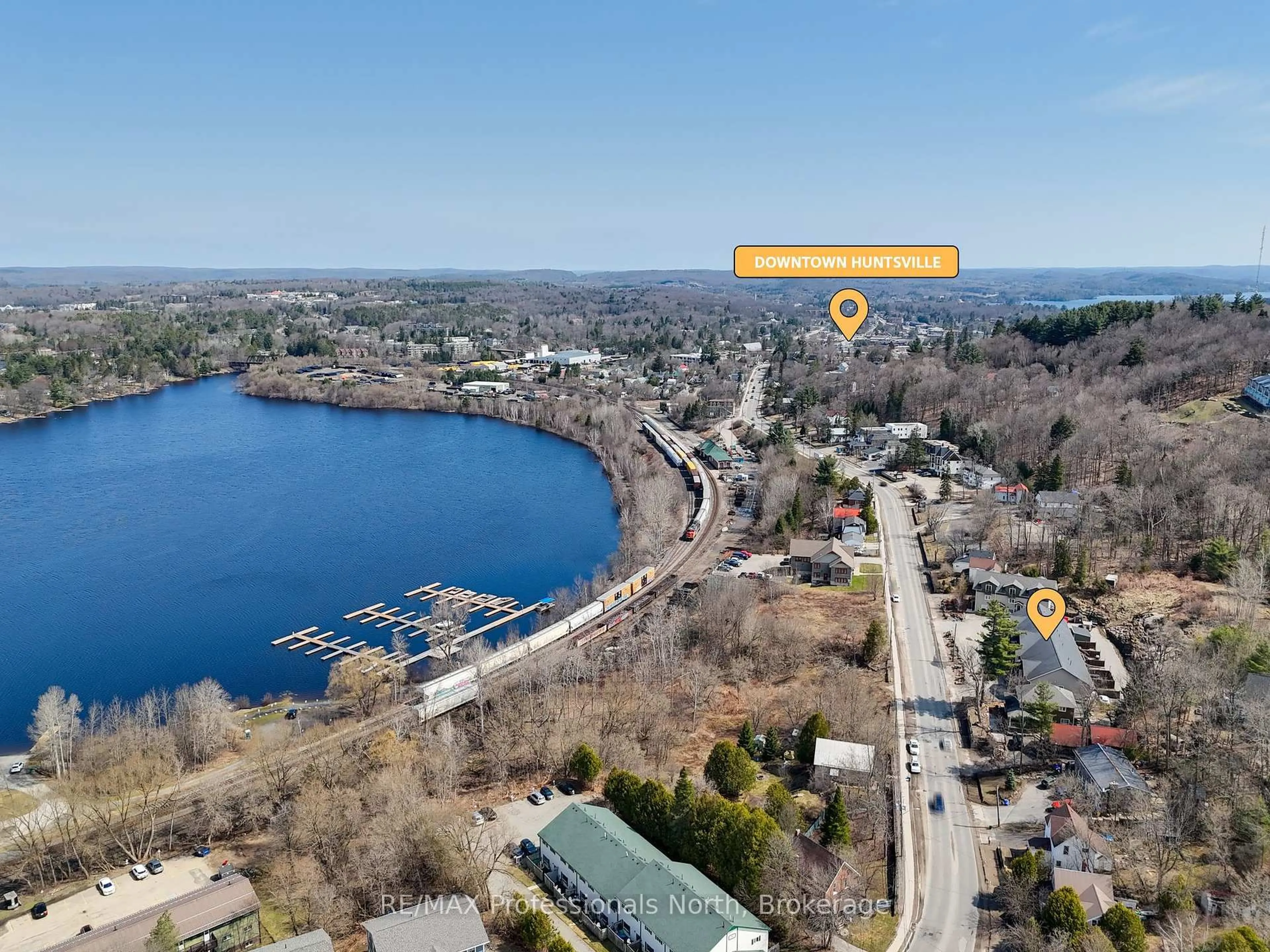 A pic from outside/outdoor area/front of a property/back of a property/a pic from drone, water/lake/river/ocean view for 99 Main St #3A & 3B, Huntsville Ontario P1H 2A8