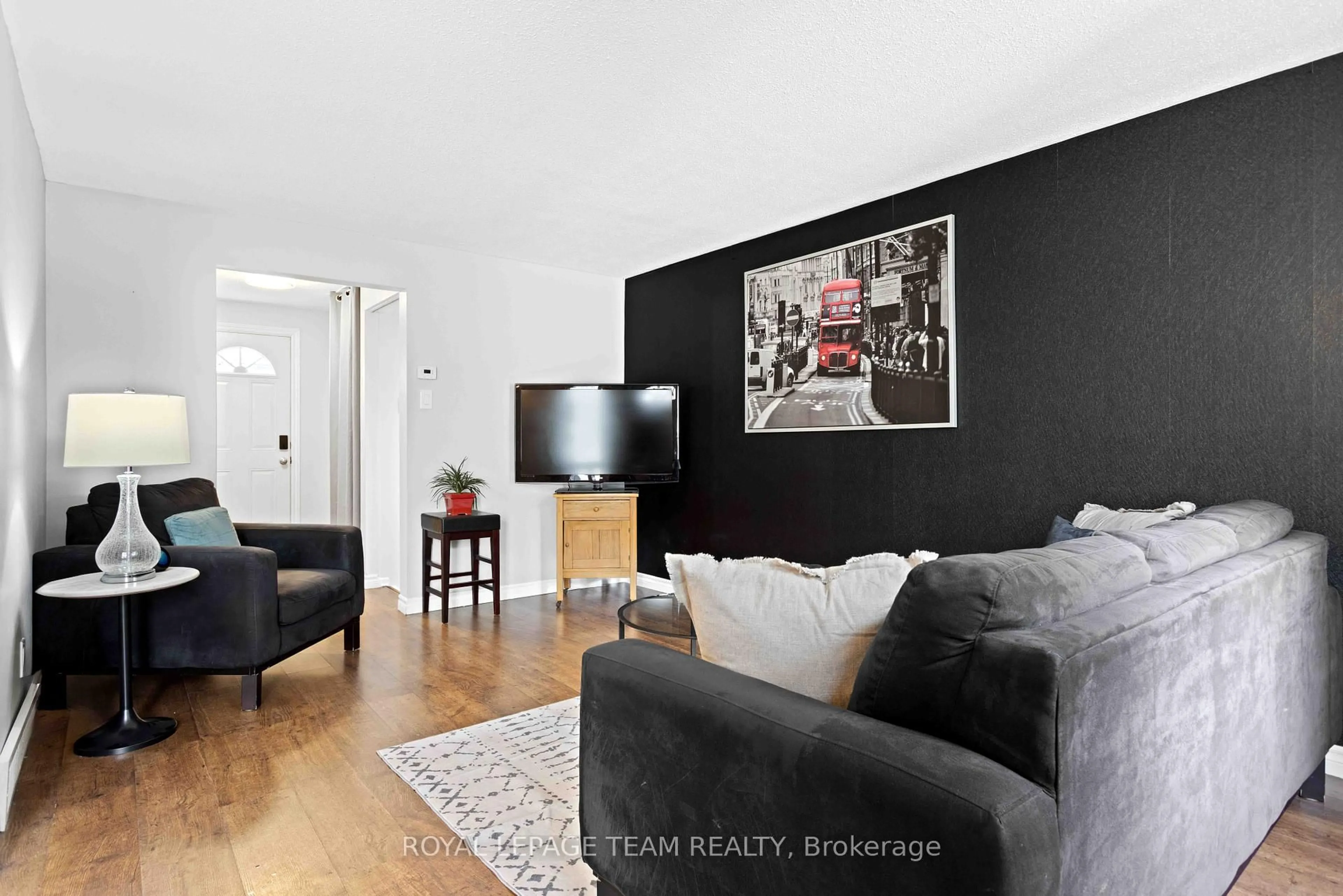 Living room with furniture, wood/laminate floor for 243 Thistledown Crt #33, Ottawa Ontario K2J 1N1