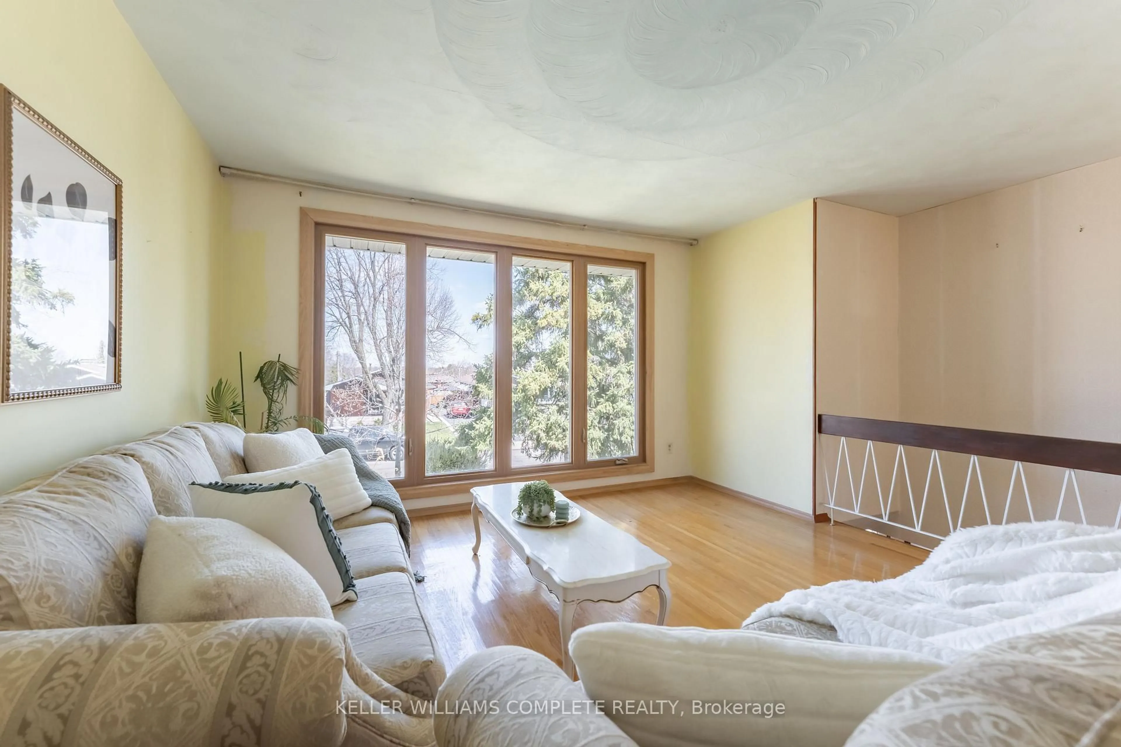 Living room with furniture, wood/laminate floor for 181 Burrwood Dr, Hamilton Ontario L9C 3T3