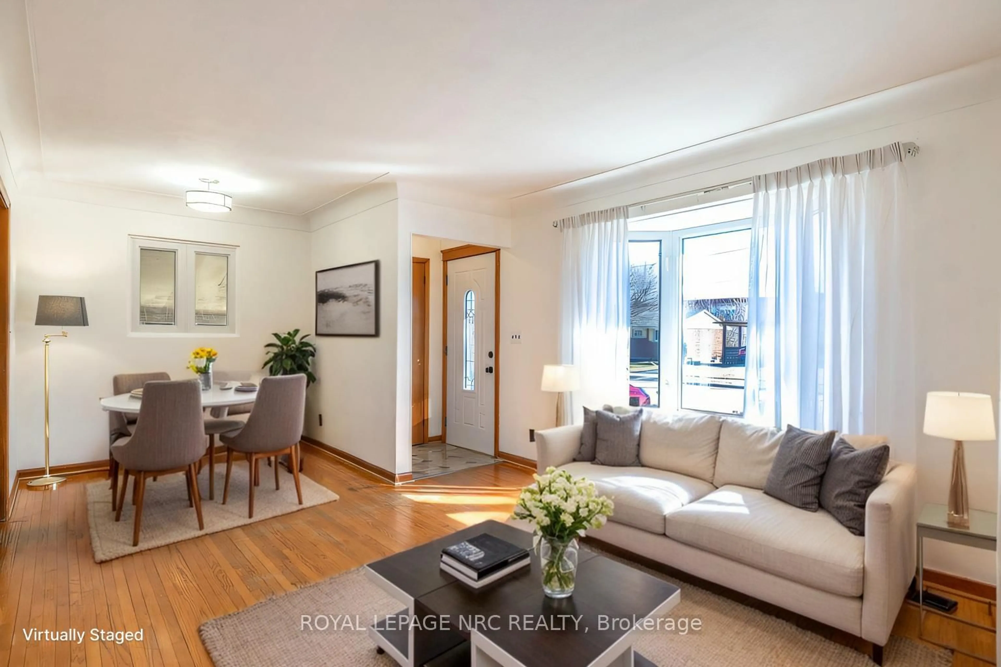 Living room with furniture, wood/laminate floor for 6543 Doreen Dr, Niagara Falls Ontario L2E 5K6
