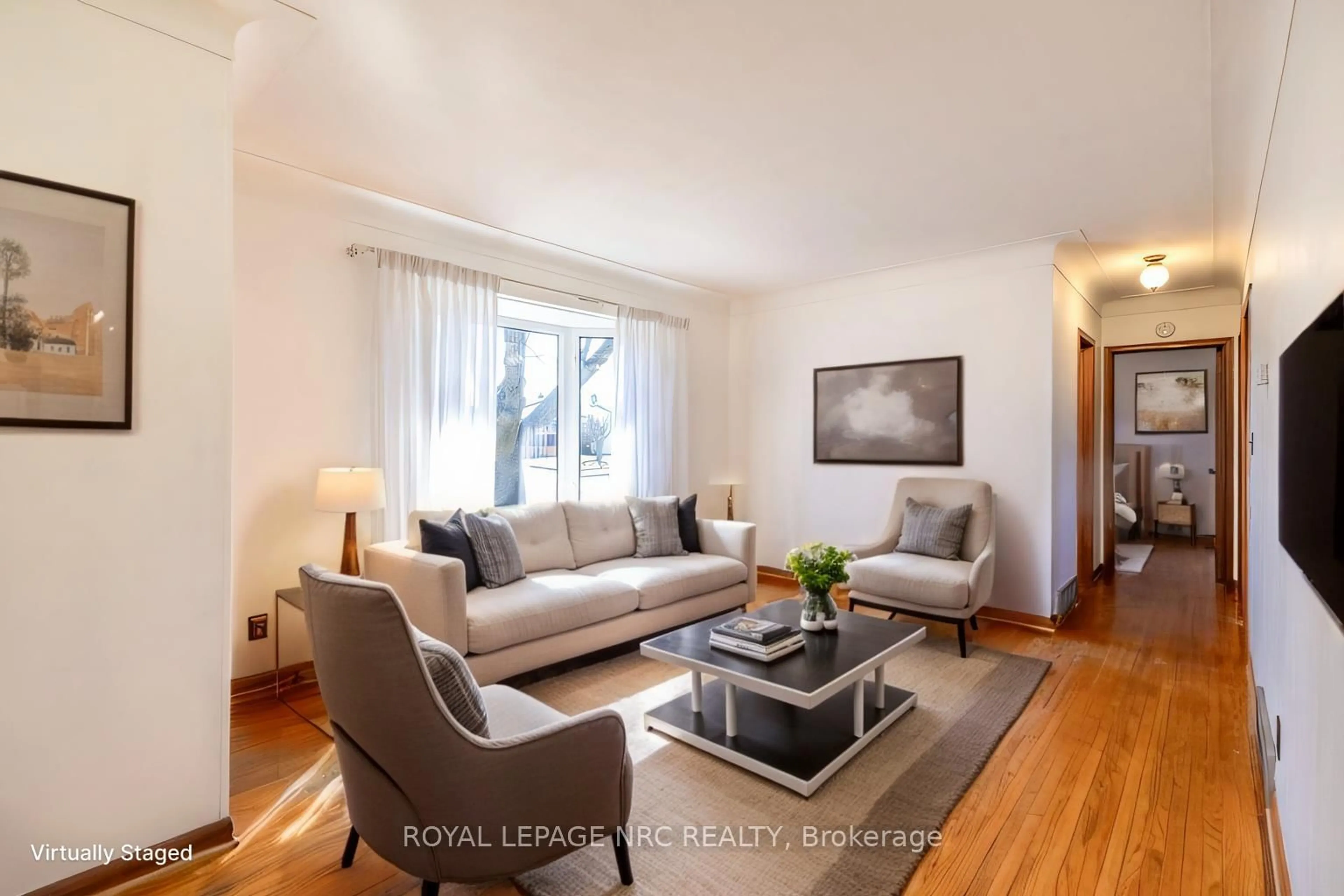 Living room with furniture, wood/laminate floor for 6543 Doreen Dr, Niagara Falls Ontario L2E 5K6