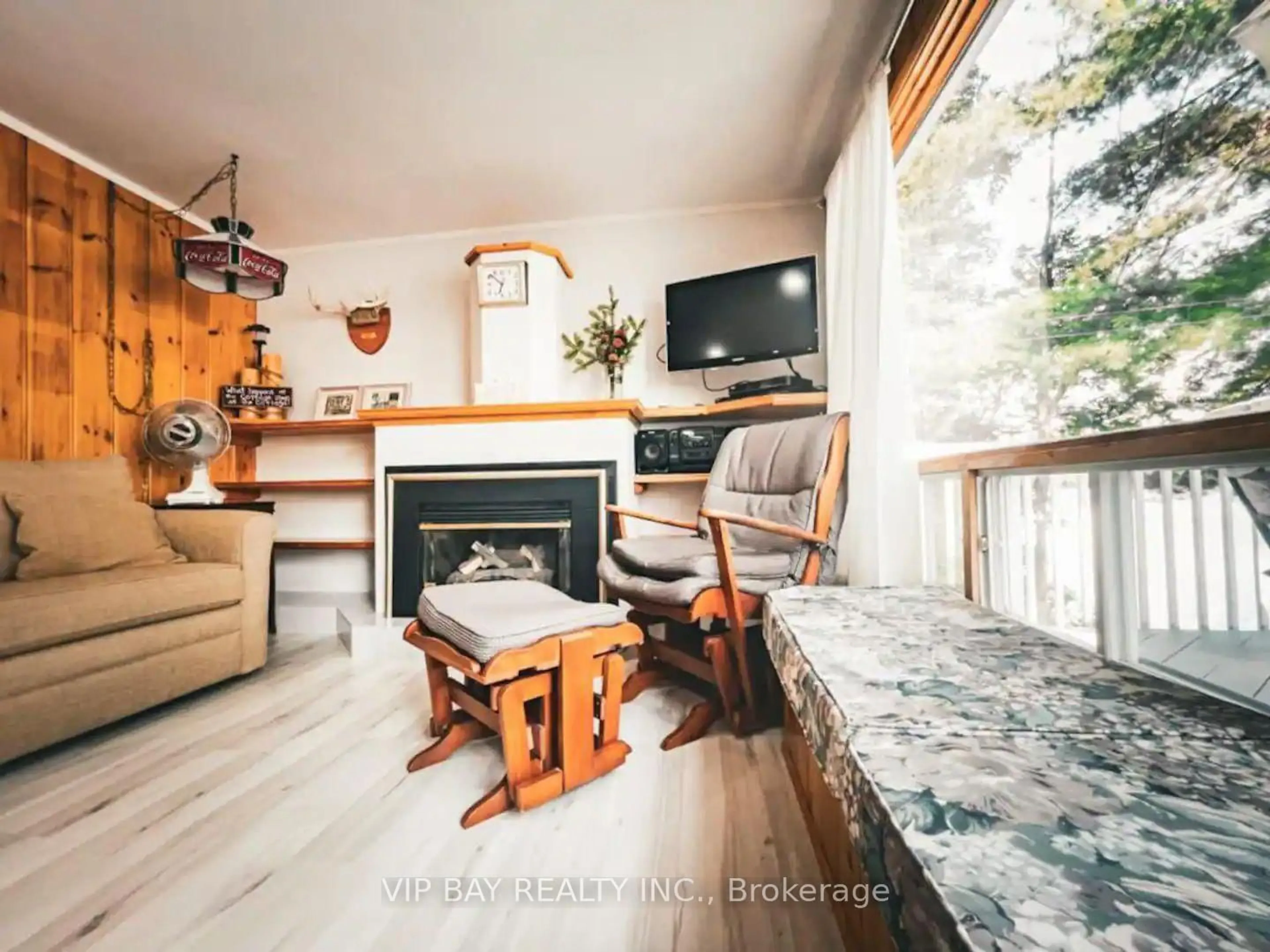Living room with furniture, wood/laminate floor for 1421 Northshore Rd, North Bay Ontario P1B 5B9