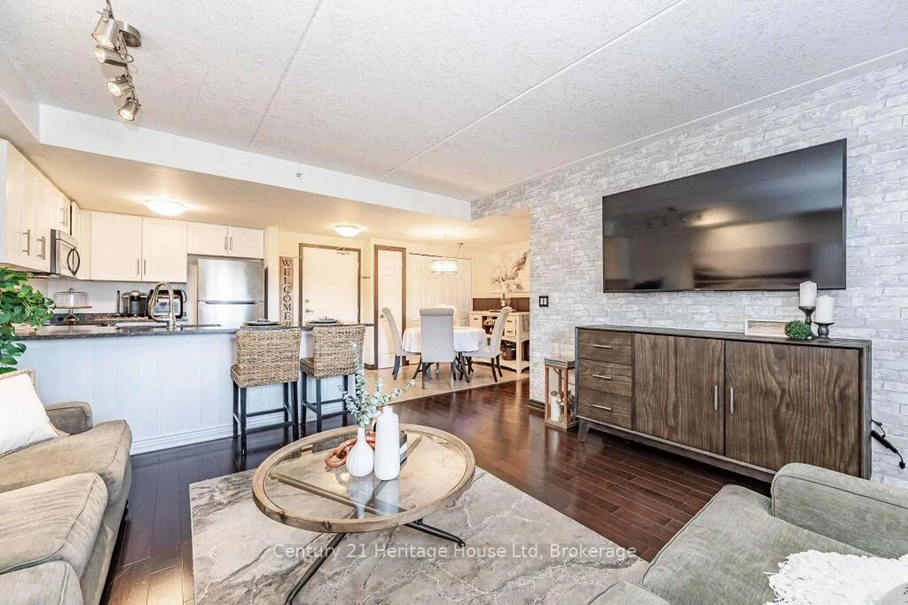 Open concept kitchen, wood/laminate floor for 43 Goodwin Dr #212, Guelph Ontario N1L 0E5