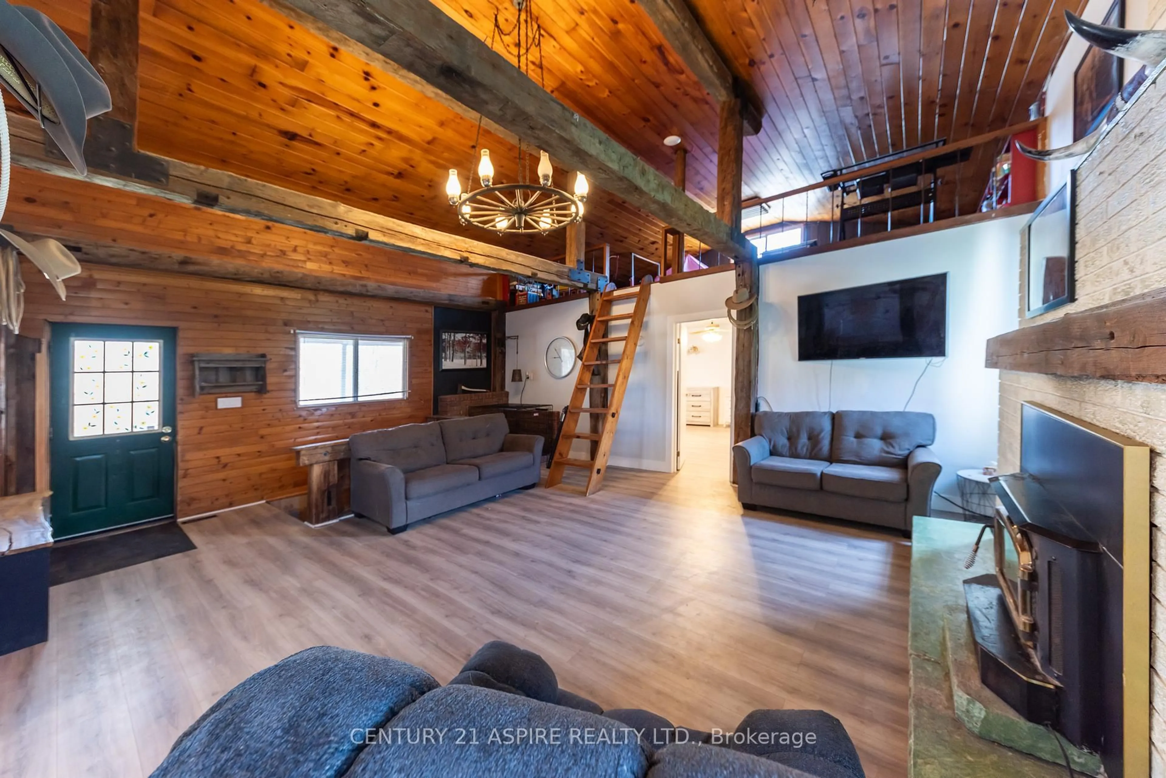 Living room with furniture, wood/laminate floor for 499 Sturgeon Mountain Rd, Pembroke Ontario K8A 6W3