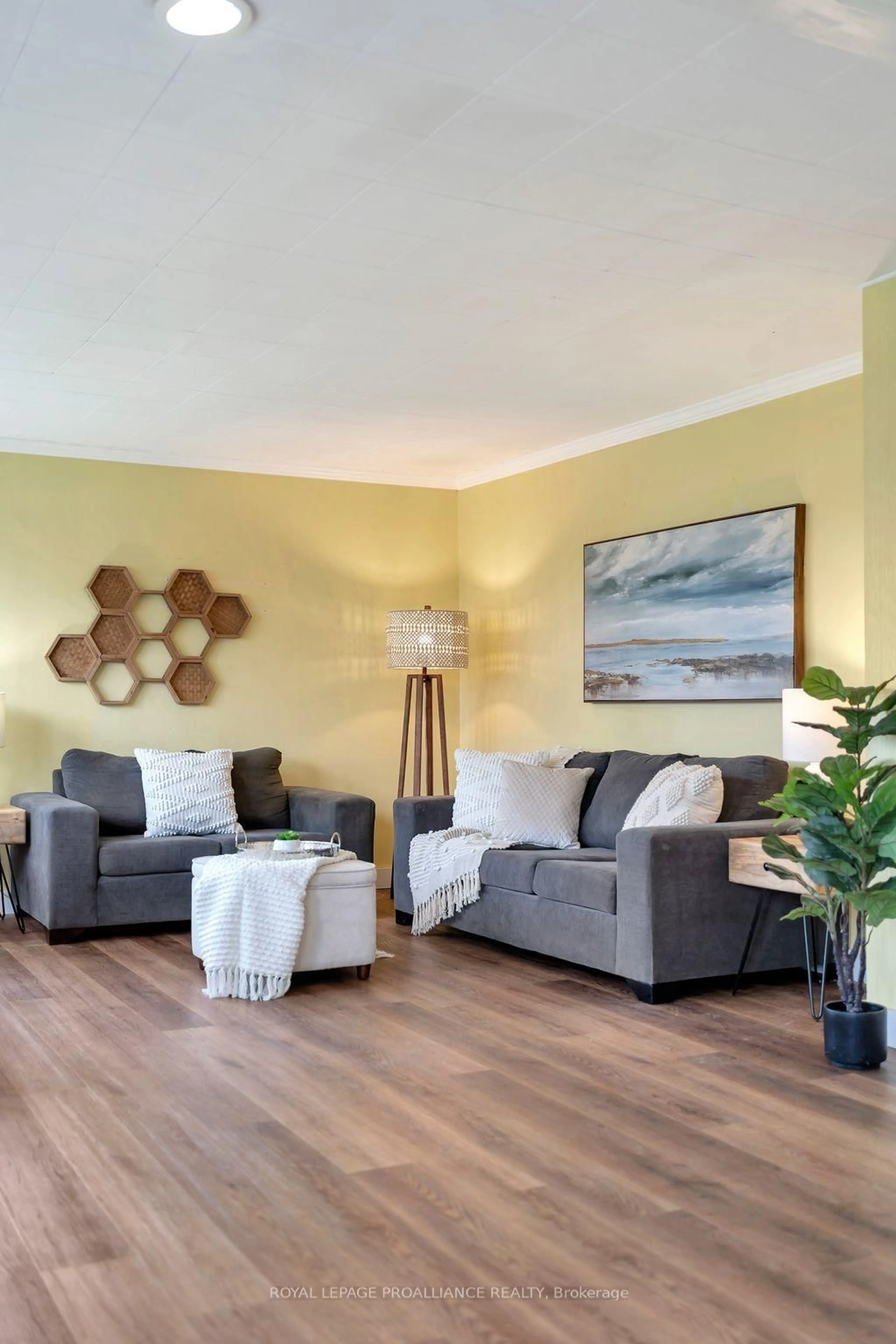 Living room with furniture, wood/laminate floor for 94 Main St, Prince Edward County Ontario K0K 3L0