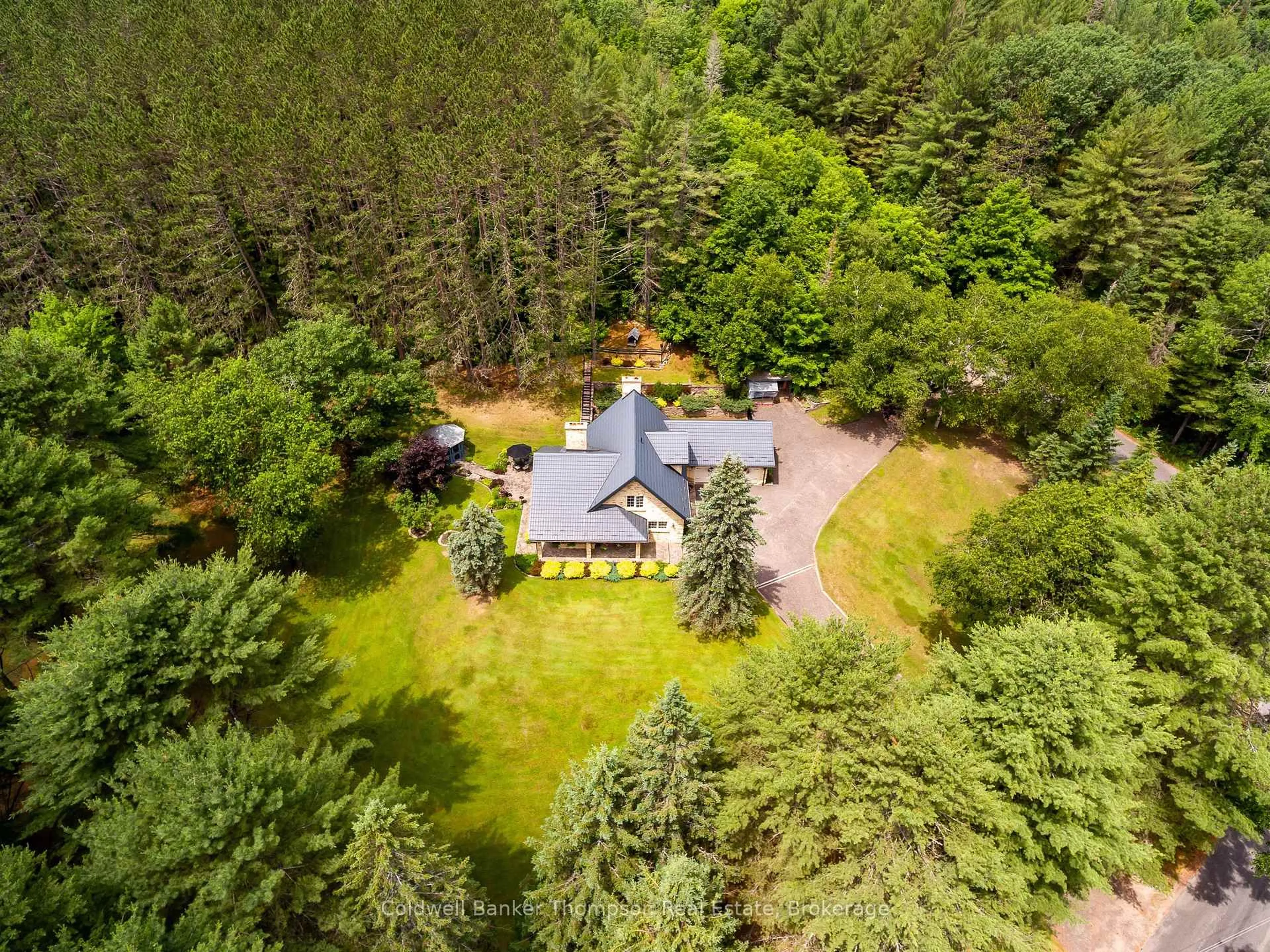 A pic from outside/outdoor area/front of a property/back of a property/a pic from drone, forest/trees view for 37 Fowlers Rd, Huntsville Ontario P1H 2N5