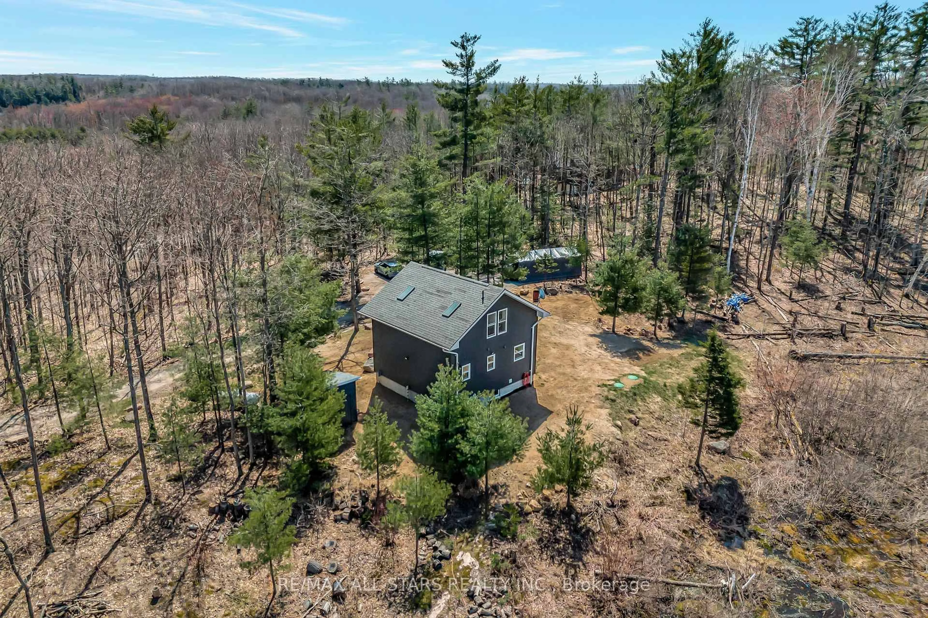 A pic from outside/outdoor area/front of a property/back of a property/a pic from drone, forest/trees view for 1295 Deep Bay Rd, Minden Hills Ontario K0M 2L0