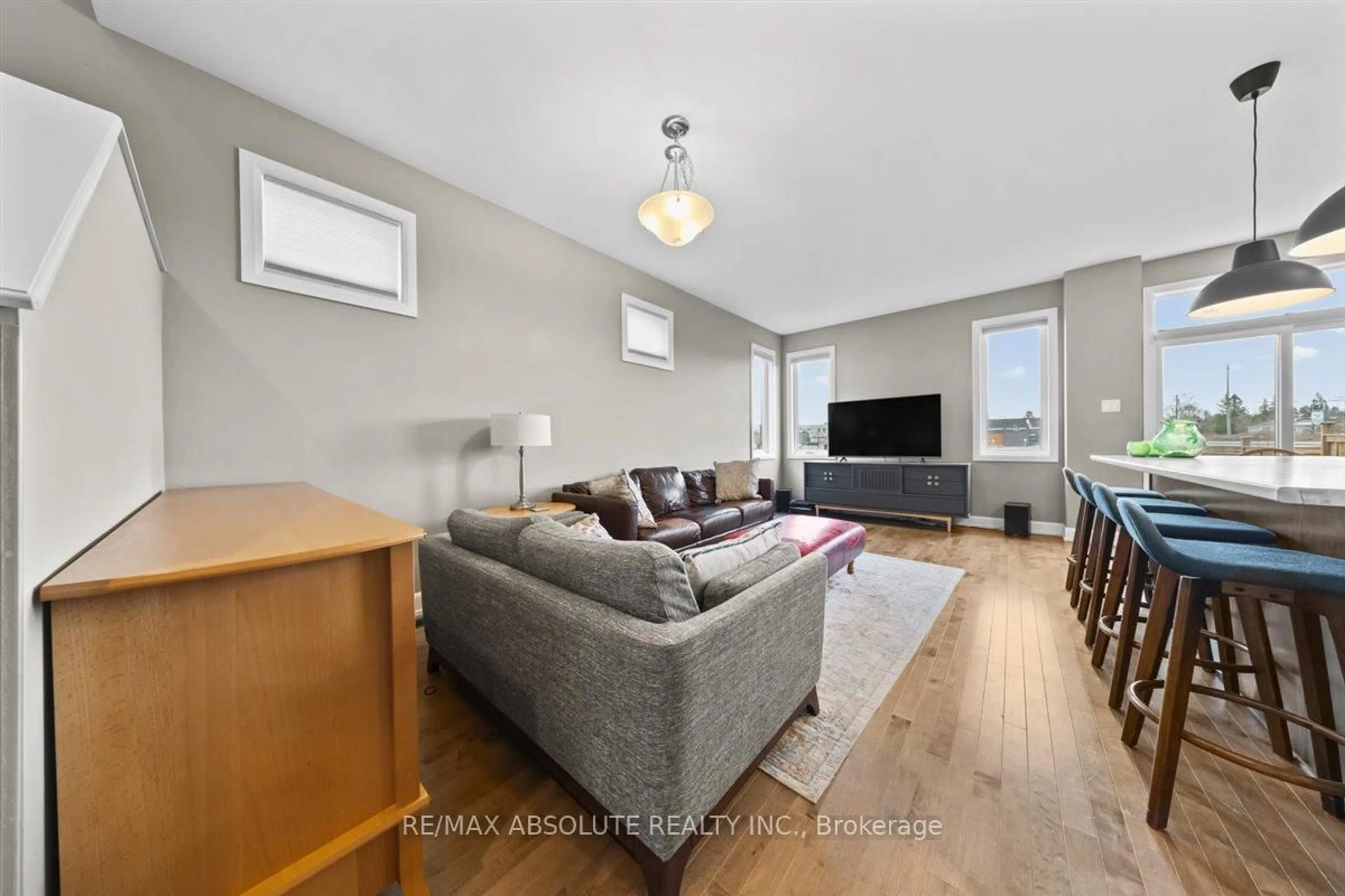 Living room with furniture, wood/laminate floor for 169 Bandelier Way, Ottawa Ontario K2S 2J5