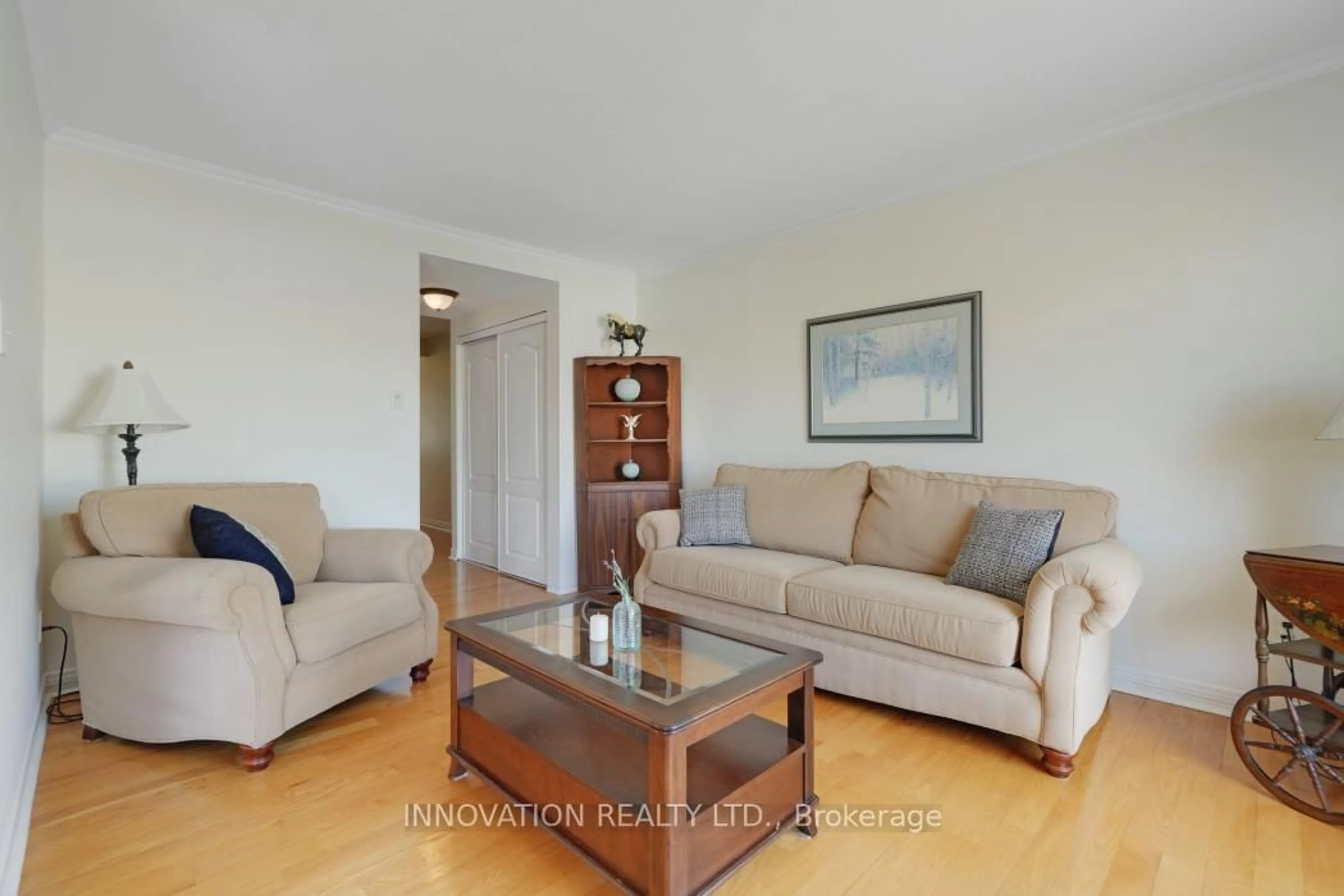 Living room with furniture, wood/laminate floor for 114 Acklam Terr, Ottawa Ontario K2K 2J5