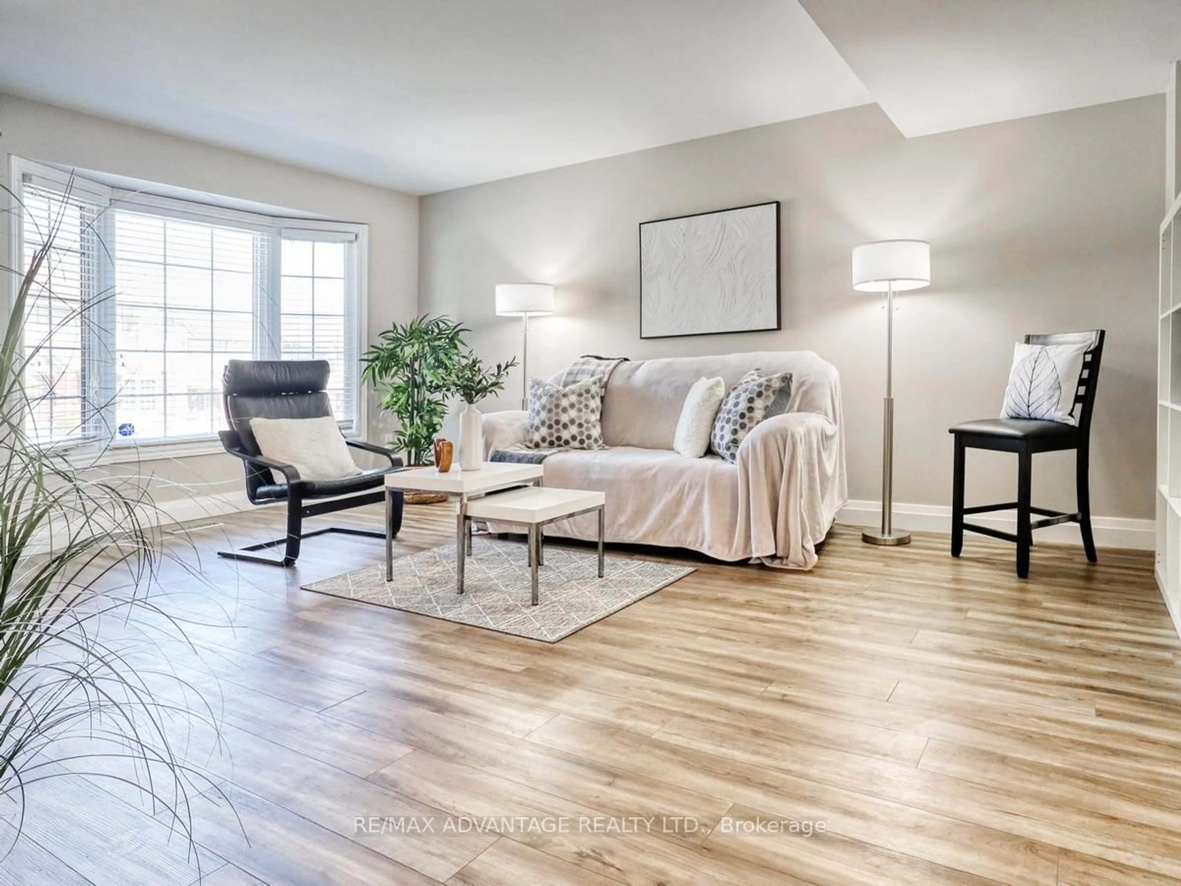 Living room with furniture, wood/laminate floor for 70 Chapman Crt #74, London North Ontario N6G 4Z4