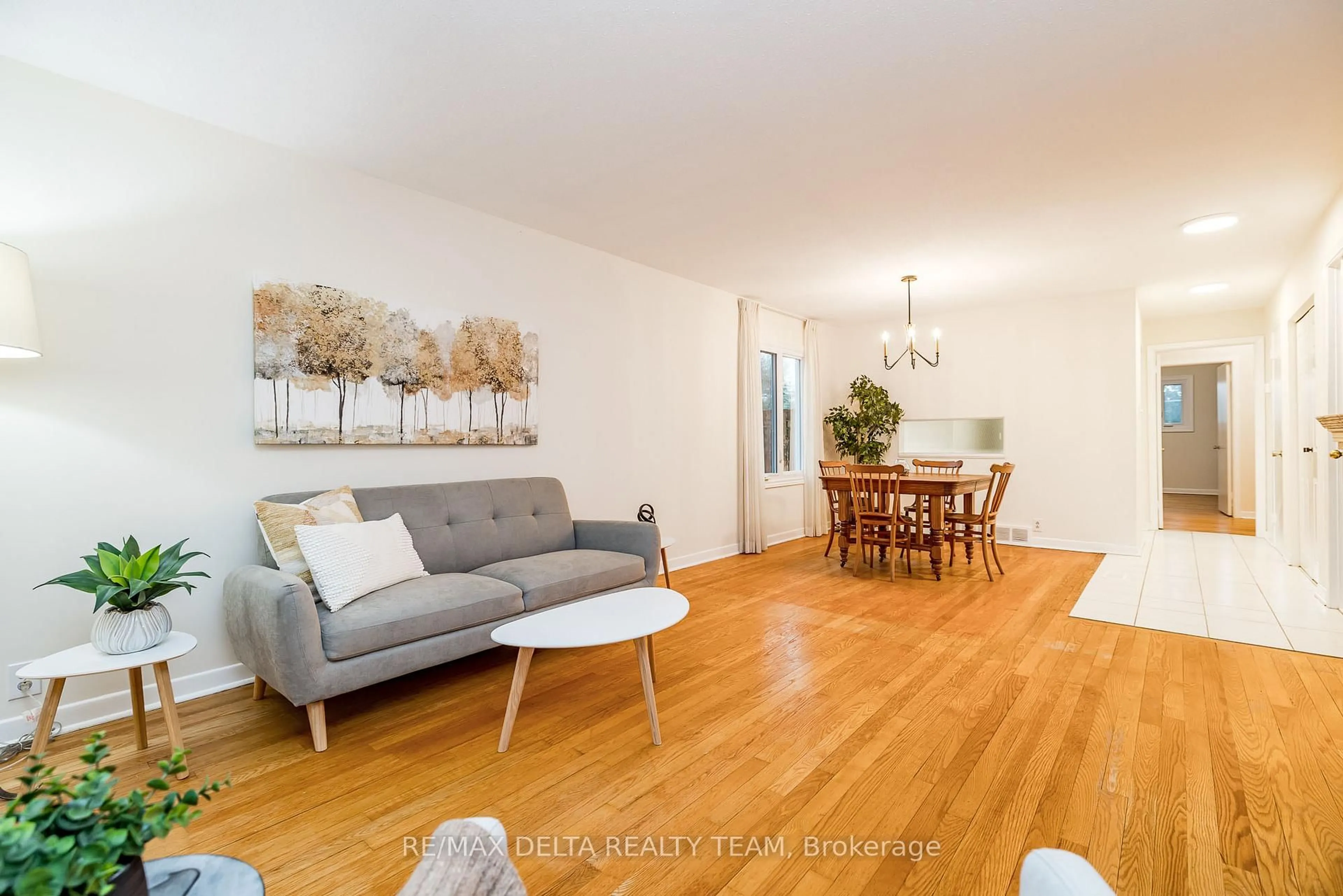 Living room with furniture, wood/laminate floor for 22 Bedale Dr, Ottawa Ontario K2H 5M1