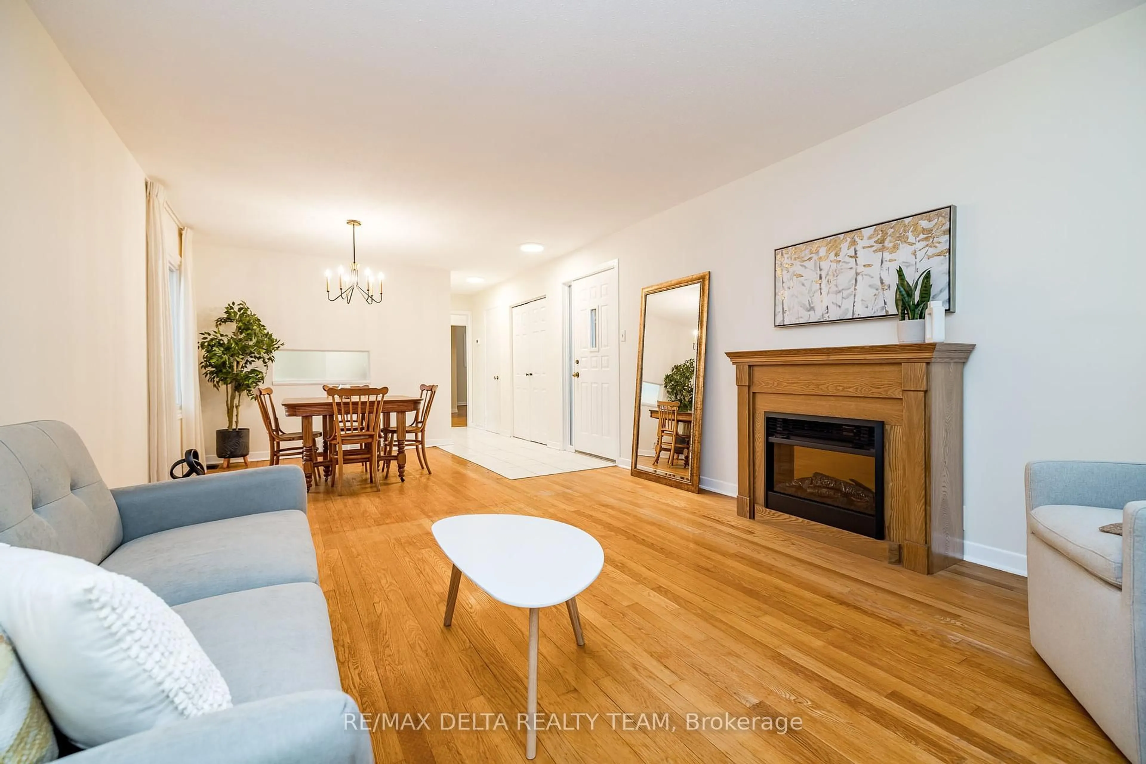 Living room with furniture, wood/laminate floor for 22 Bedale Dr, Ottawa Ontario K2H 5M1