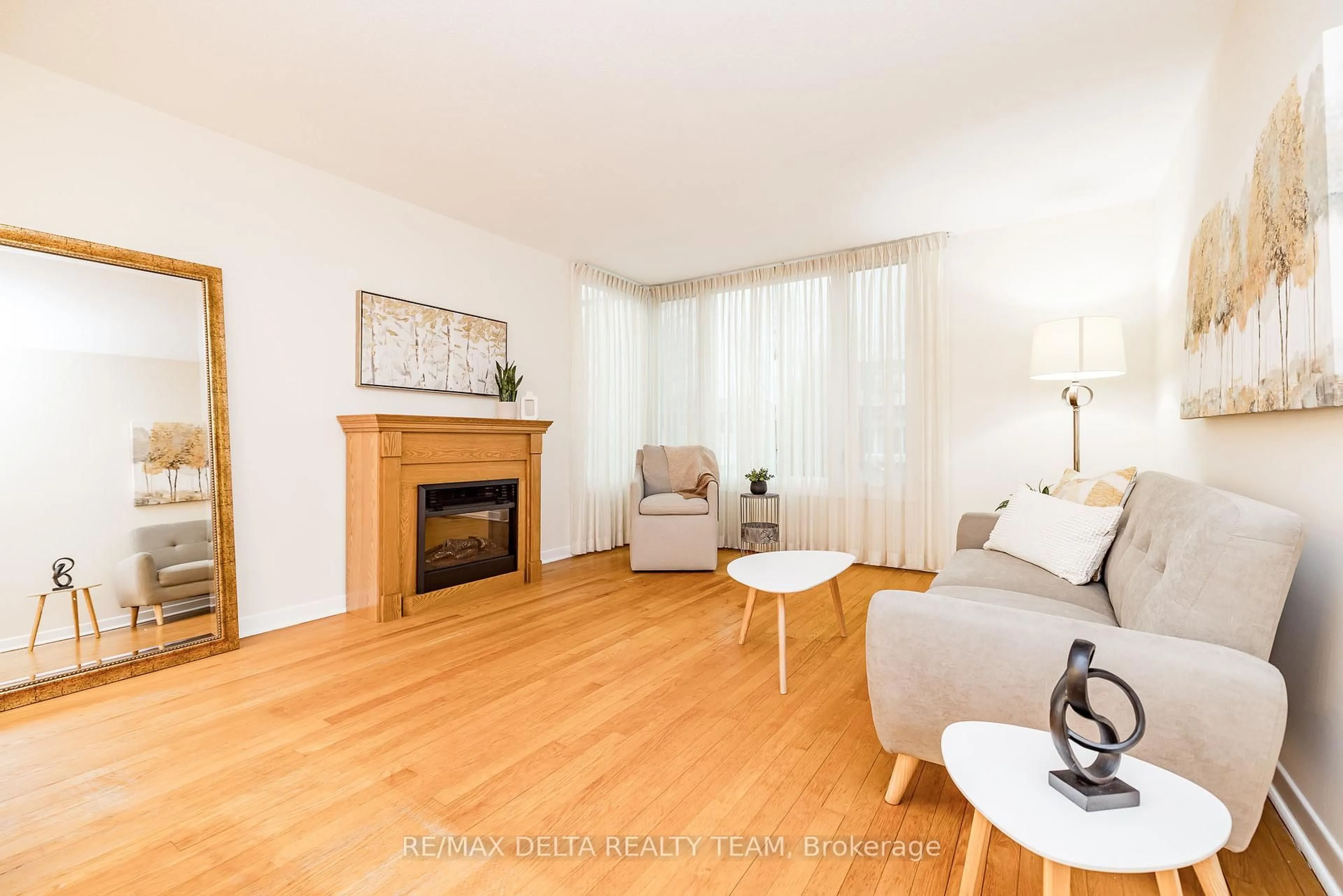 Living room with furniture, wood/laminate floor for 22 Bedale Dr, Ottawa Ontario K2H 5M1