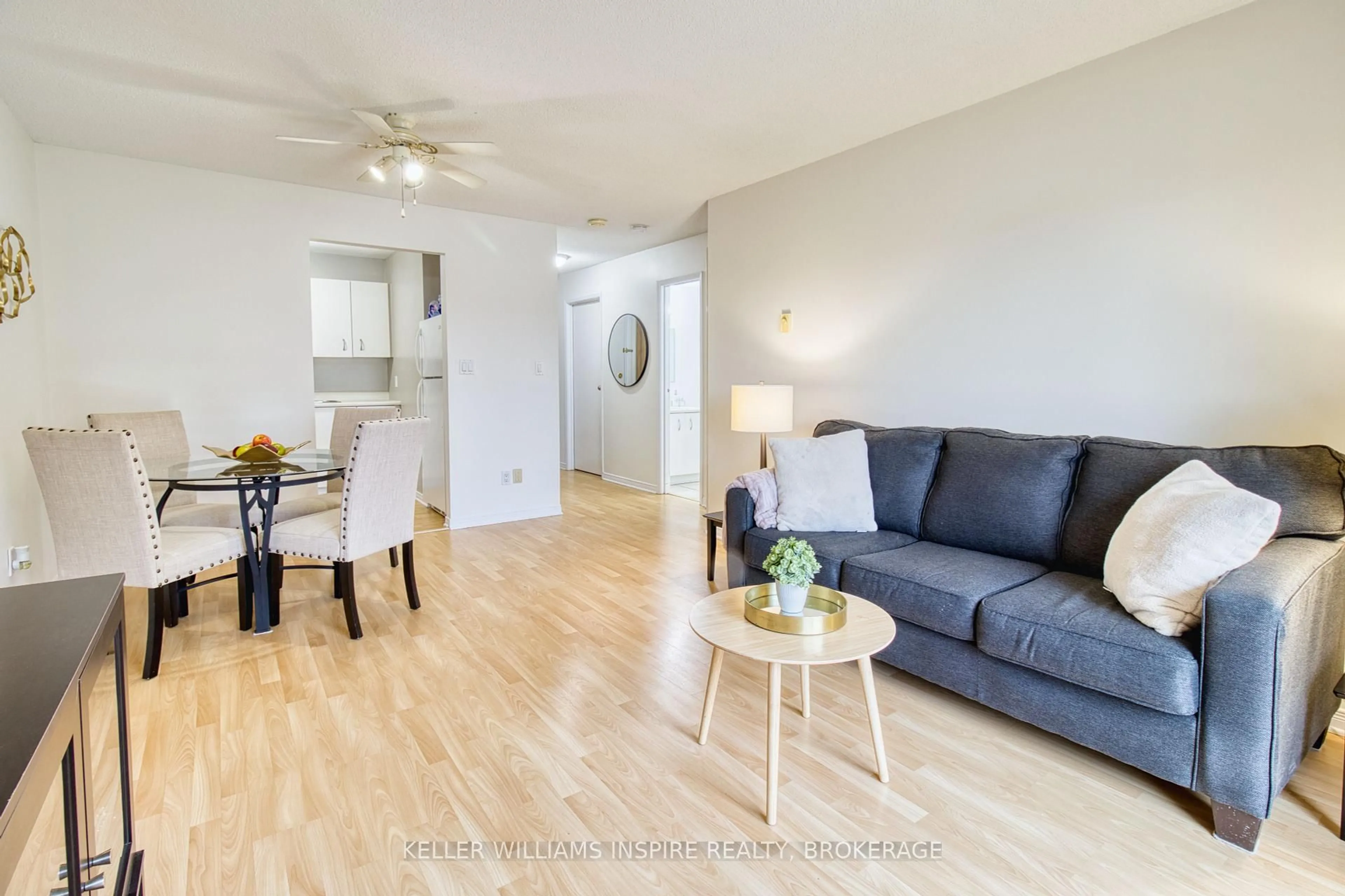 Living room with furniture, wood/laminate floor for 566 Armstrong Rd #213, Kingston Ontario K7M 8M2