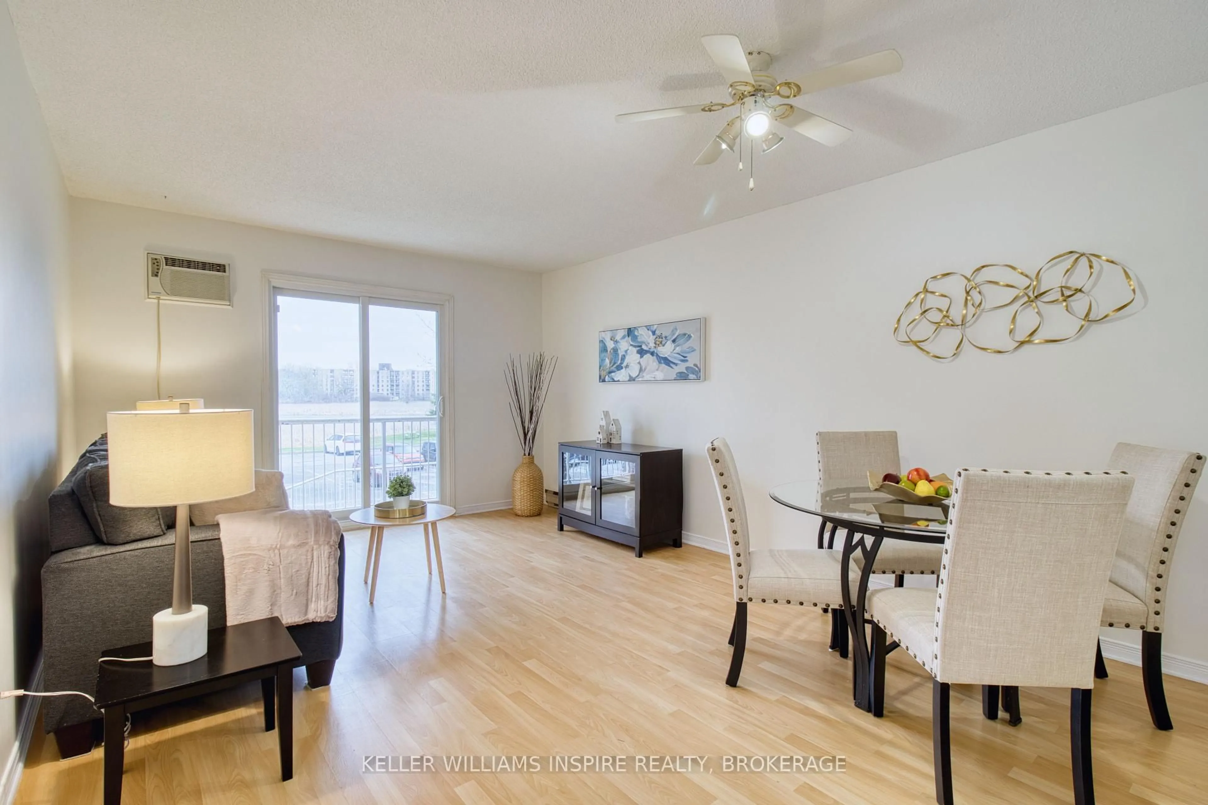 Living room with furniture, wood/laminate floor for 566 Armstrong Rd #213, Kingston Ontario K7M 8M2