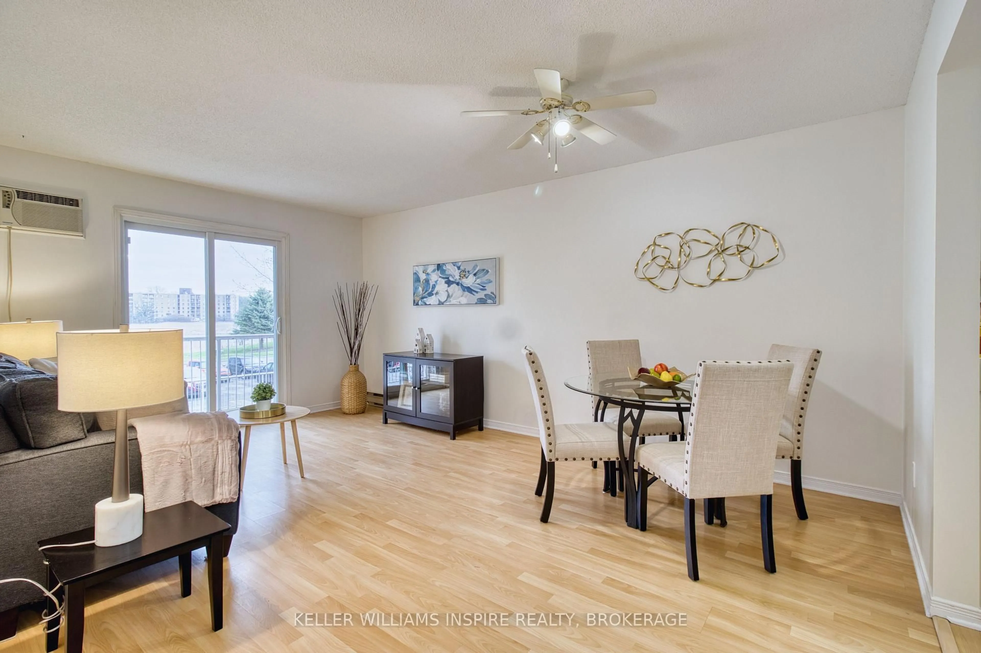 Living room with furniture, wood/laminate floor for 566 Armstrong Rd #213, Kingston Ontario K7M 8M2