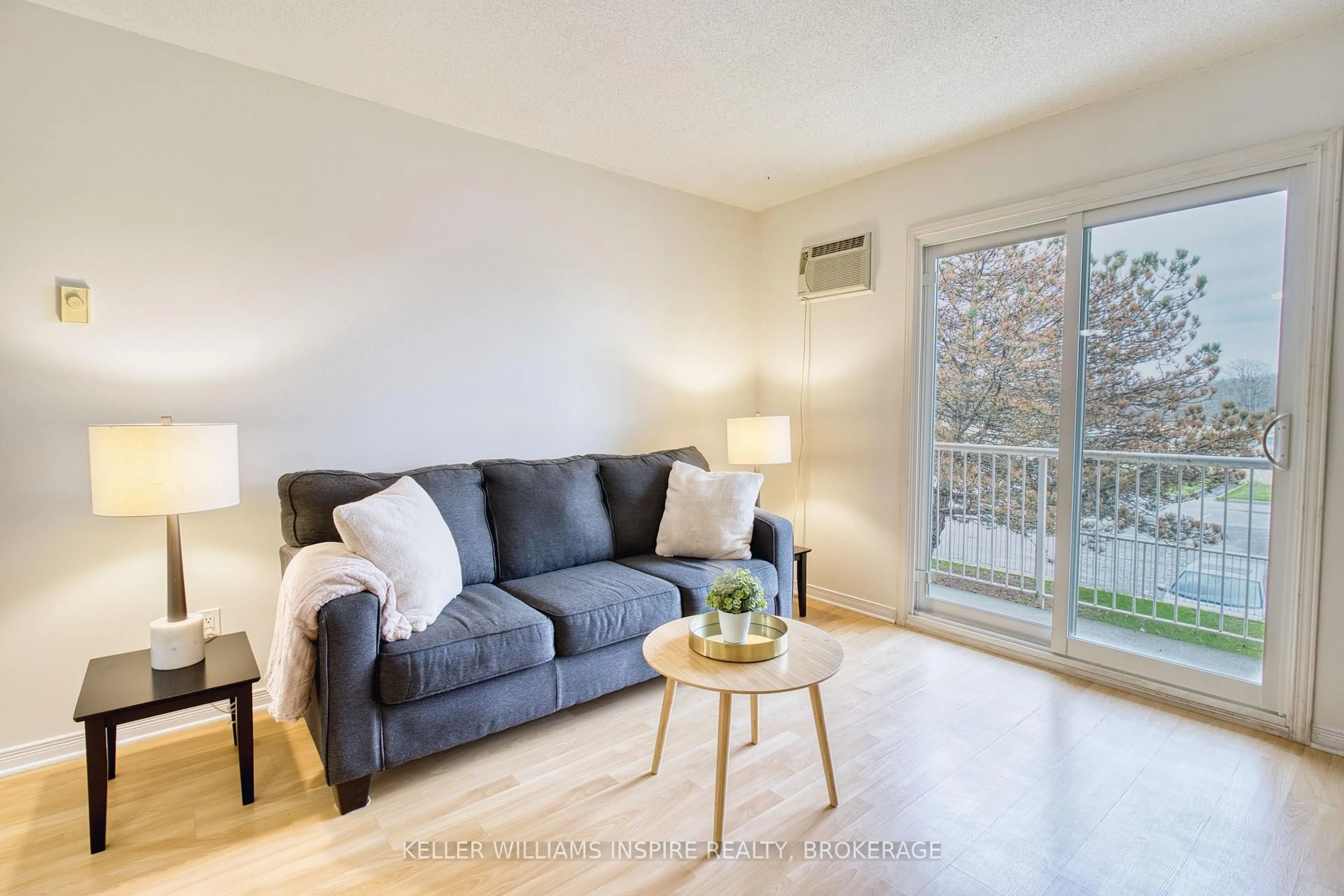 Living room with furniture, wood/laminate floor for 566 Armstrong Rd #213, Kingston Ontario K7M 8M2