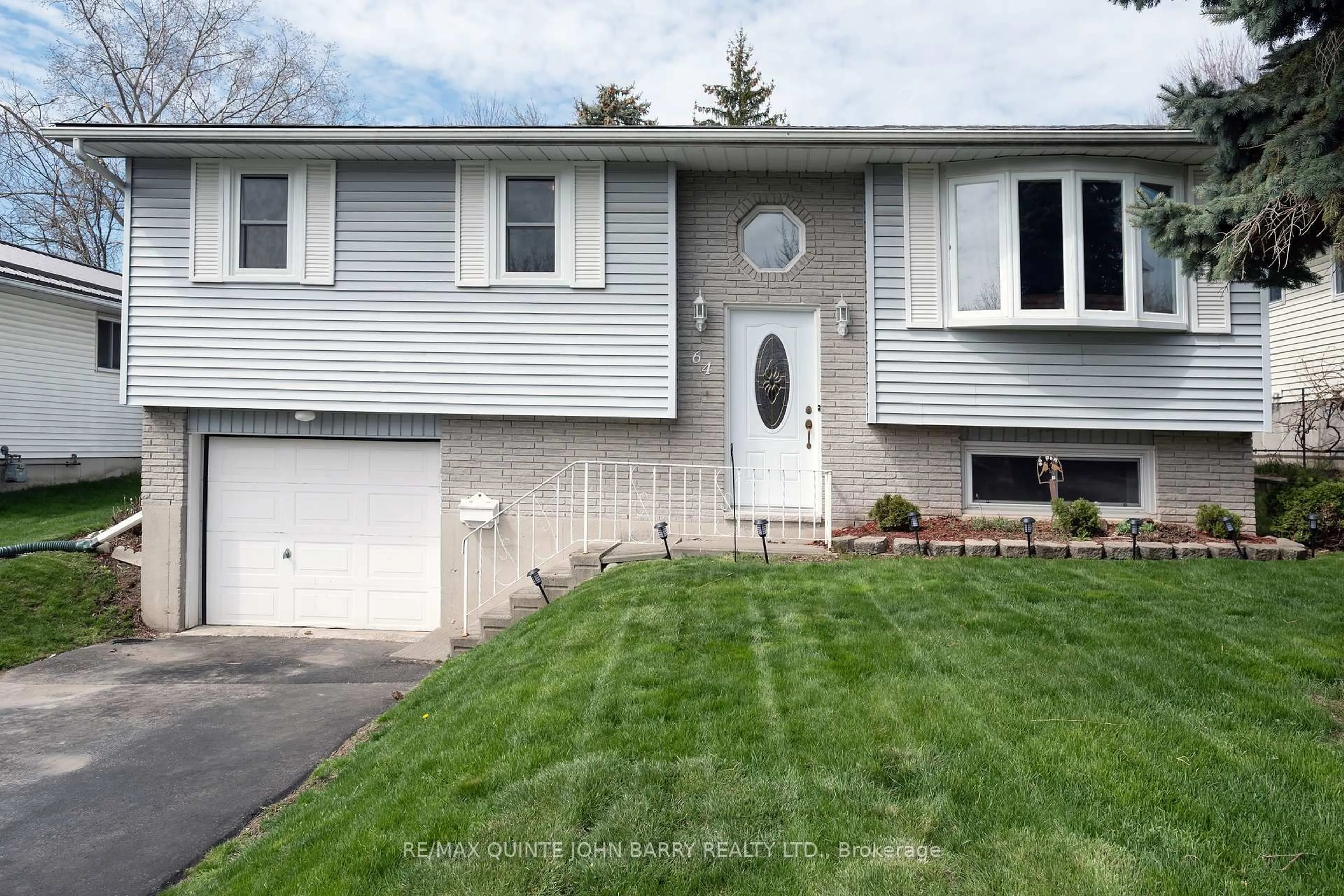 Home with vinyl exterior material, street for 64 Ireland Dr, Quinte West Ontario K8V 5X3