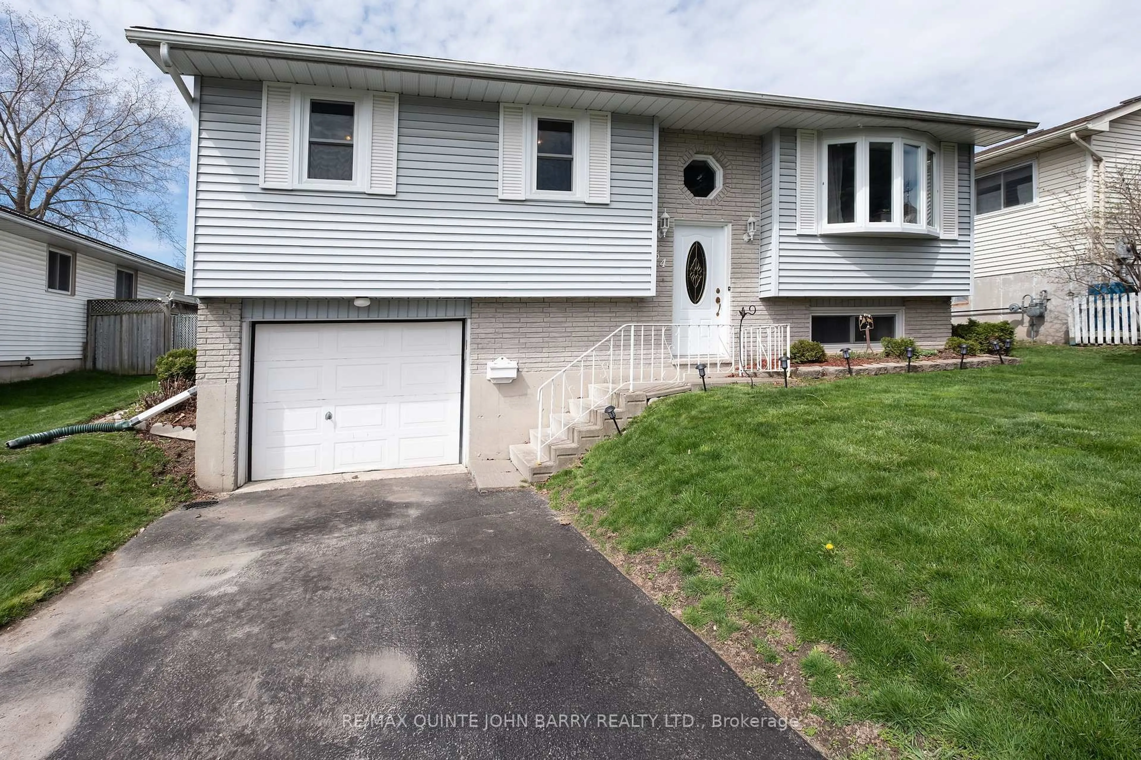 Home with vinyl exterior material, street for 64 Ireland Dr, Quinte West Ontario K8V 5X3