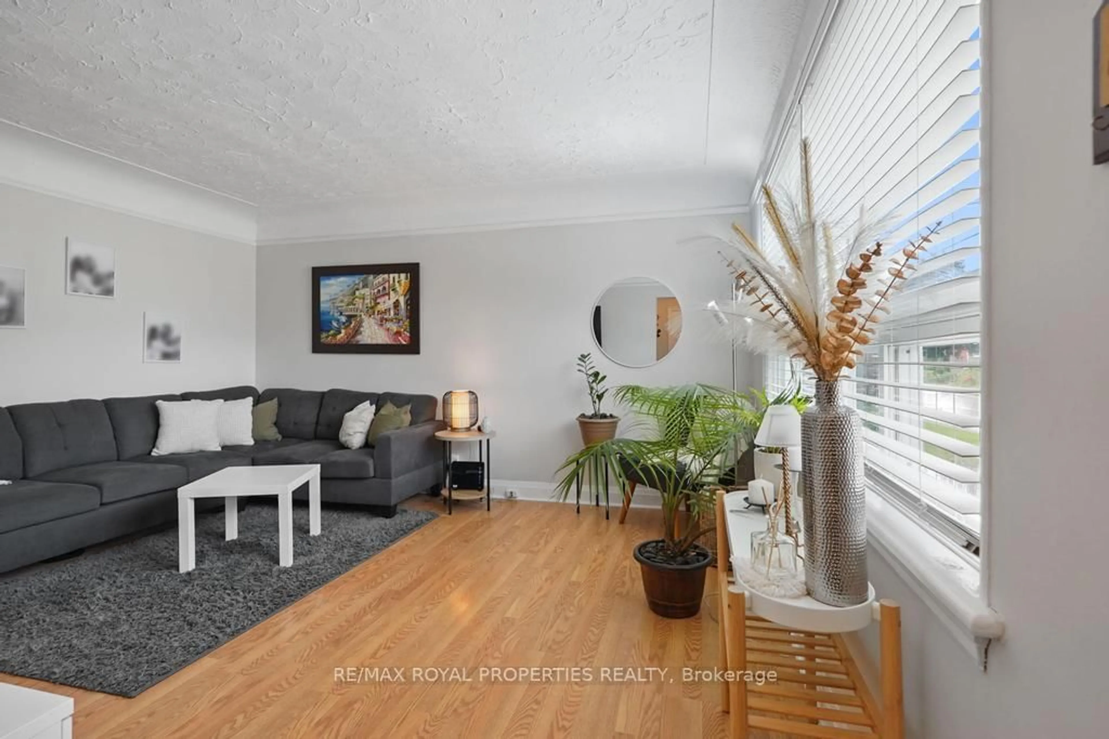 Living room with furniture, wood/laminate floor for 27 David Ave, Hamilton Ontario L9A 3T9
