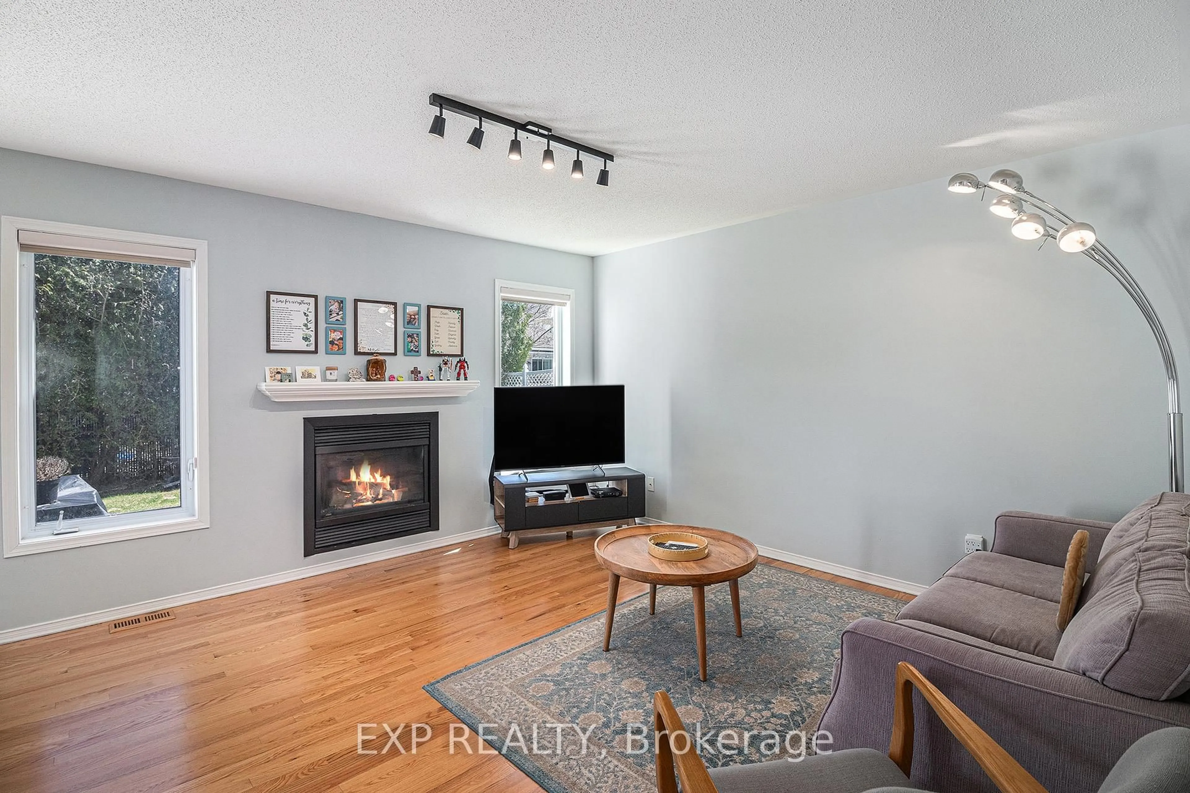 Living room with furniture, wood/laminate floor for 2123 Esprit Dr, Orleans Ontario K4A 4K2