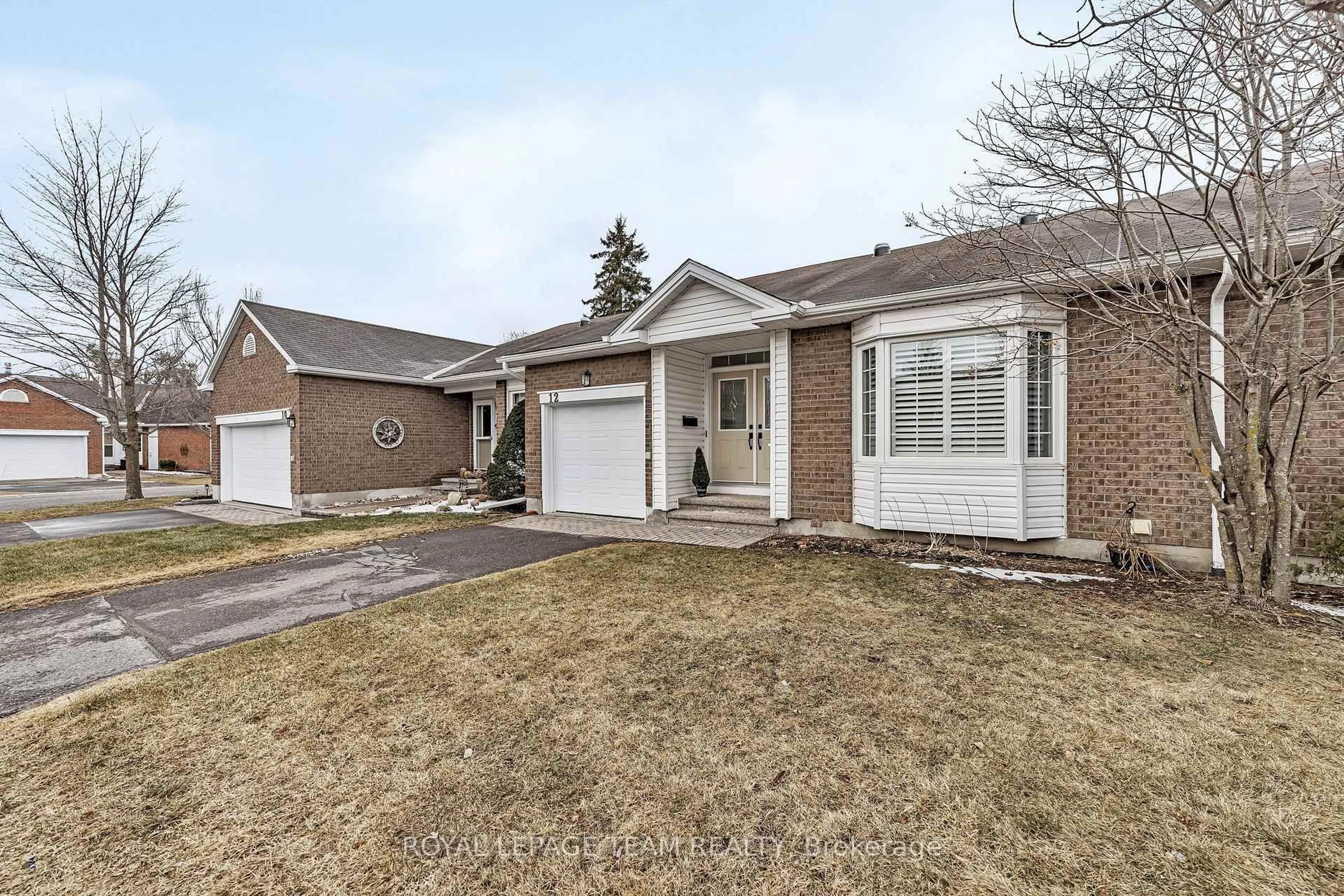 Home with brick exterior material, street for 12 Grand Harbour Crt, Stittsville Ontario K2S 1H1