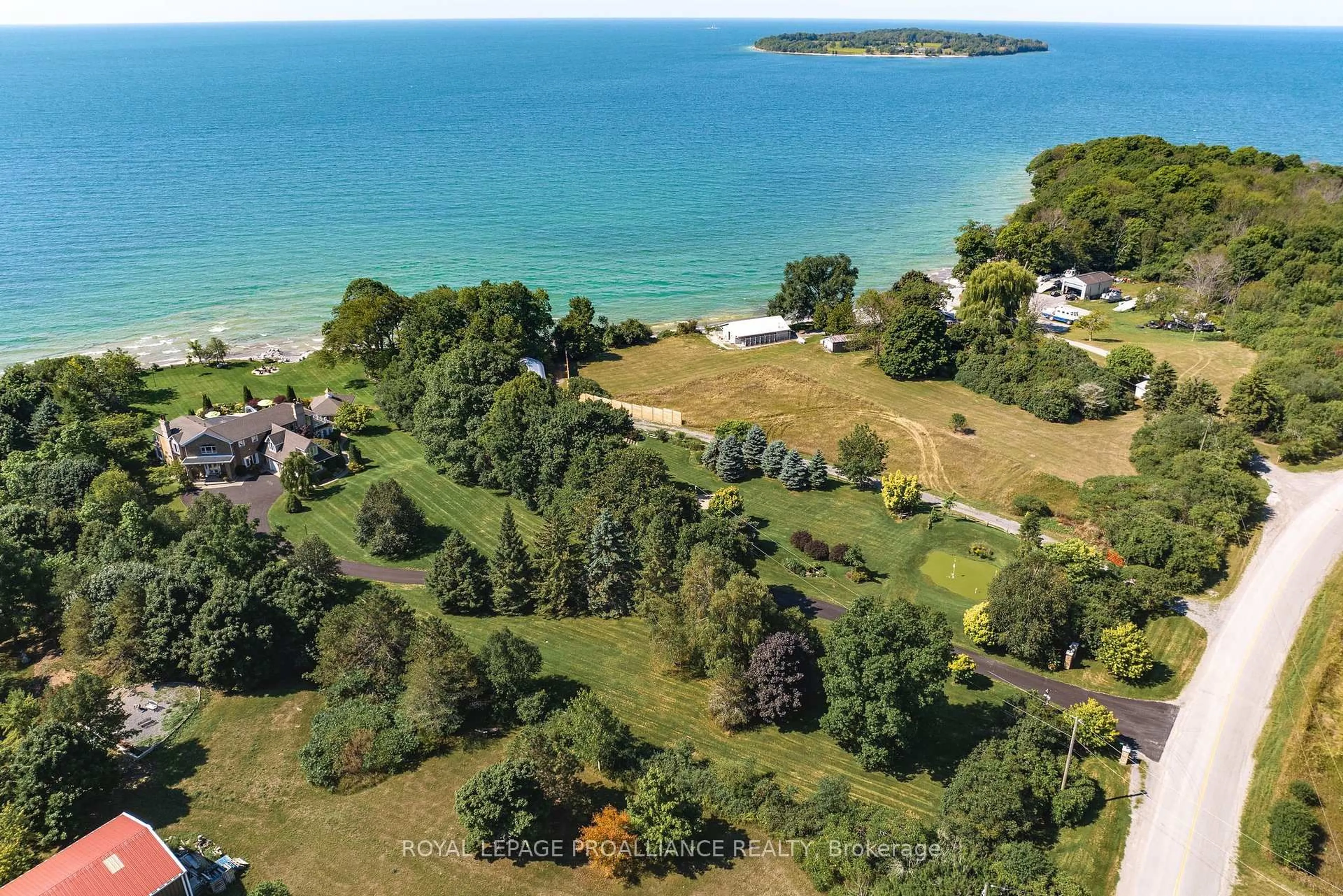 A pic from outside/outdoor area/front of a property/back of a property/a pic from drone, water/lake/river/ocean view for 1261 County Rd 20 Rd, Prince Edward County Ontario K0K 3L0
