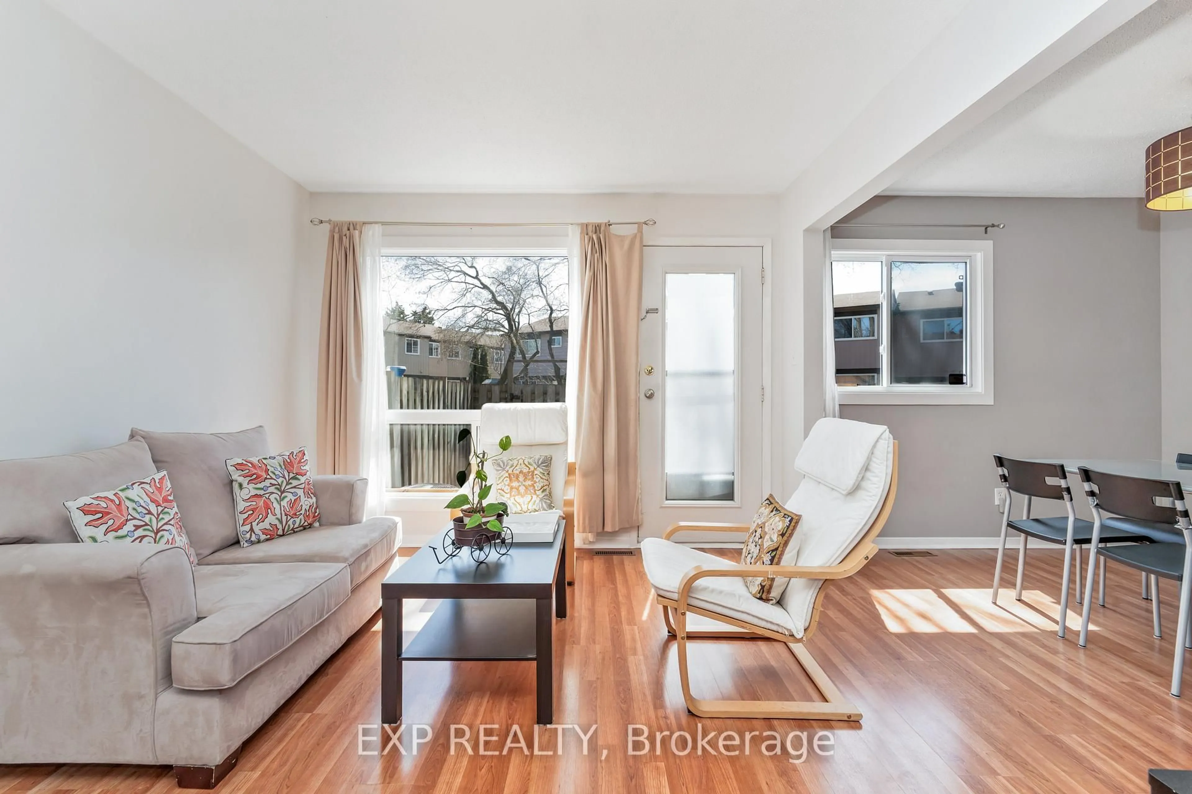 Living room with furniture, wood/laminate floor for 44 FOXFIELD Dr #D, Ottawa Ontario K2J 1P7