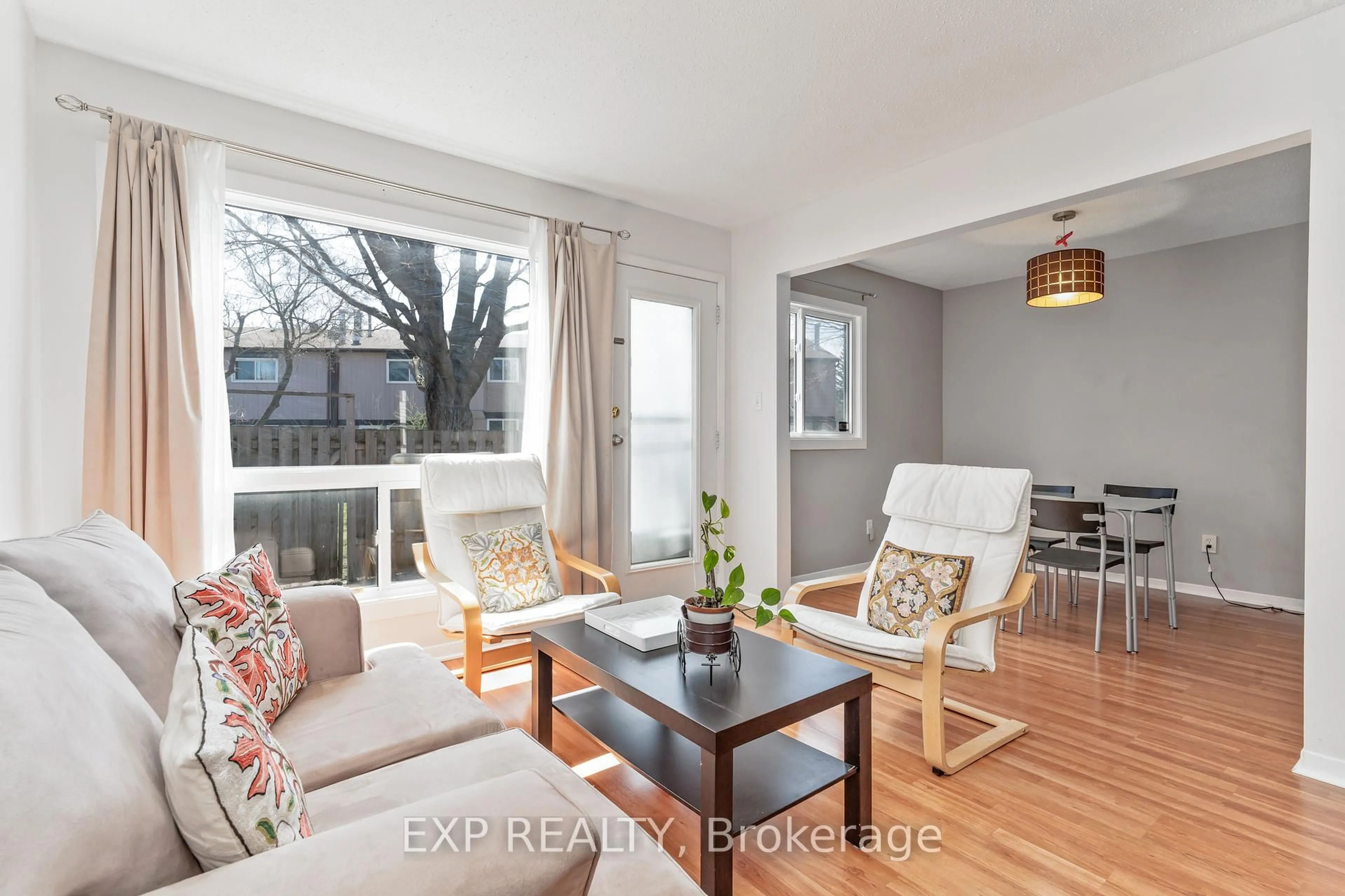 Living room with furniture, wood/laminate floor for 44 FOXFIELD Dr #D, Ottawa Ontario K2J 1P7